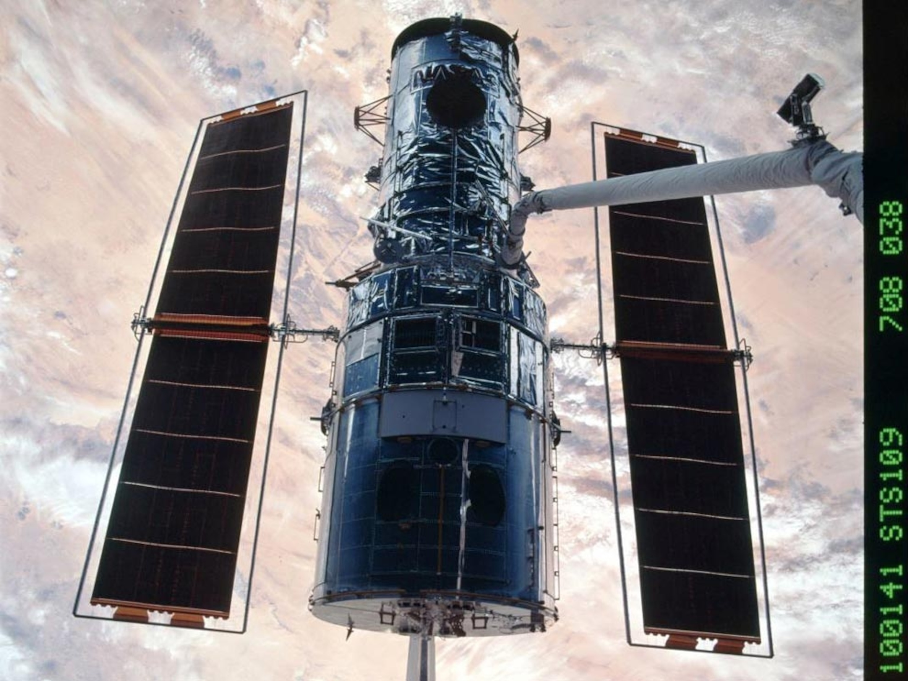 Hubble floating over land