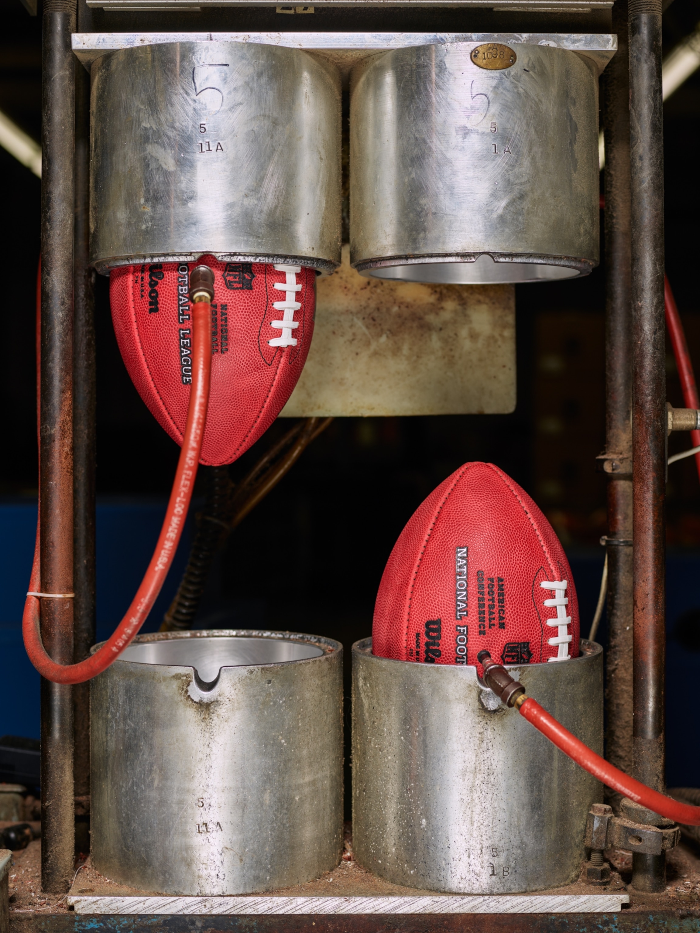 Footballs in a chamber to inflate and shape them.