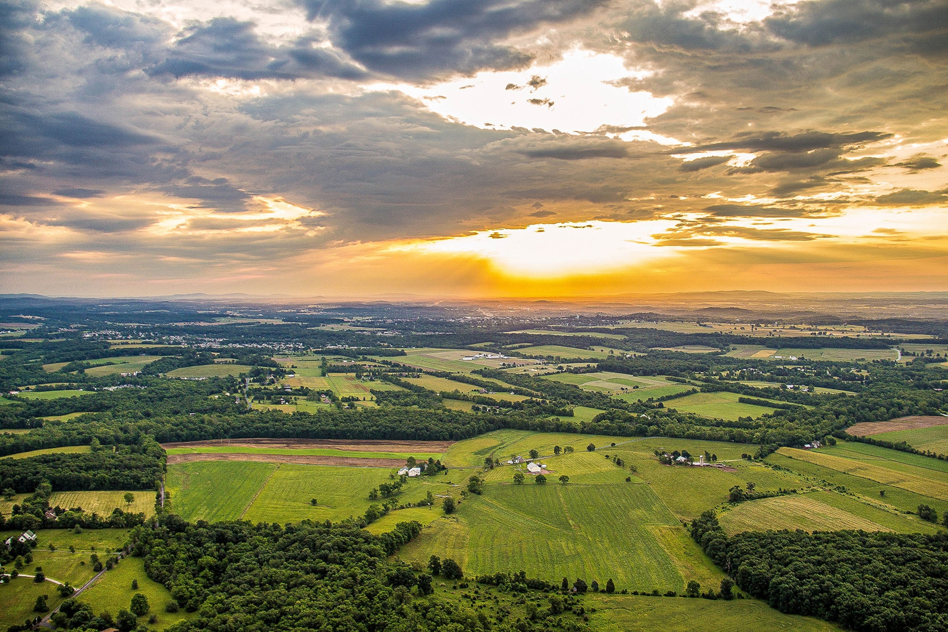 An aerial view of the green farmlands surrounding Gettysburg at sunset.