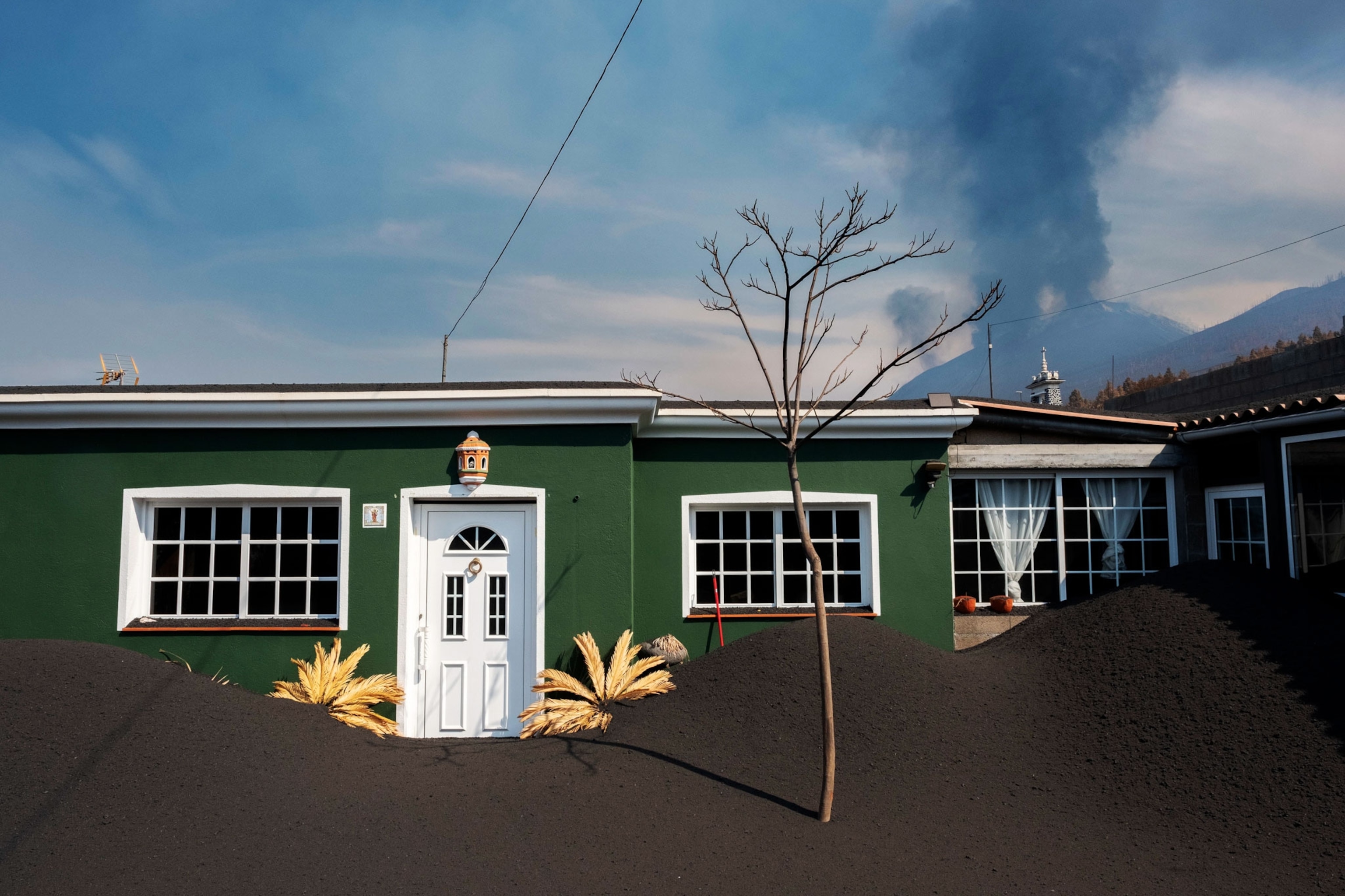 A green house covered in black volcanic ash in the Las Manchas neighborhood.