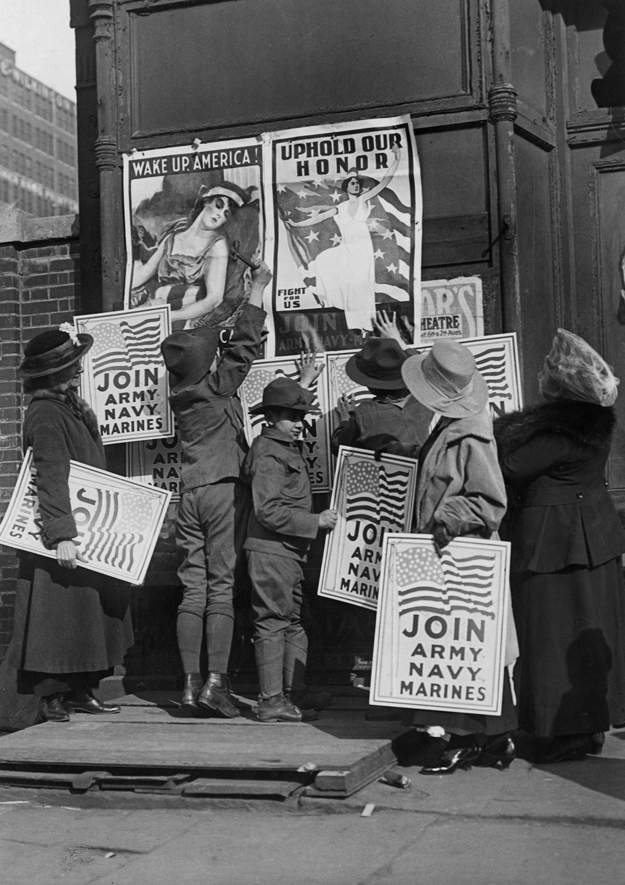 women and children pasting war posters