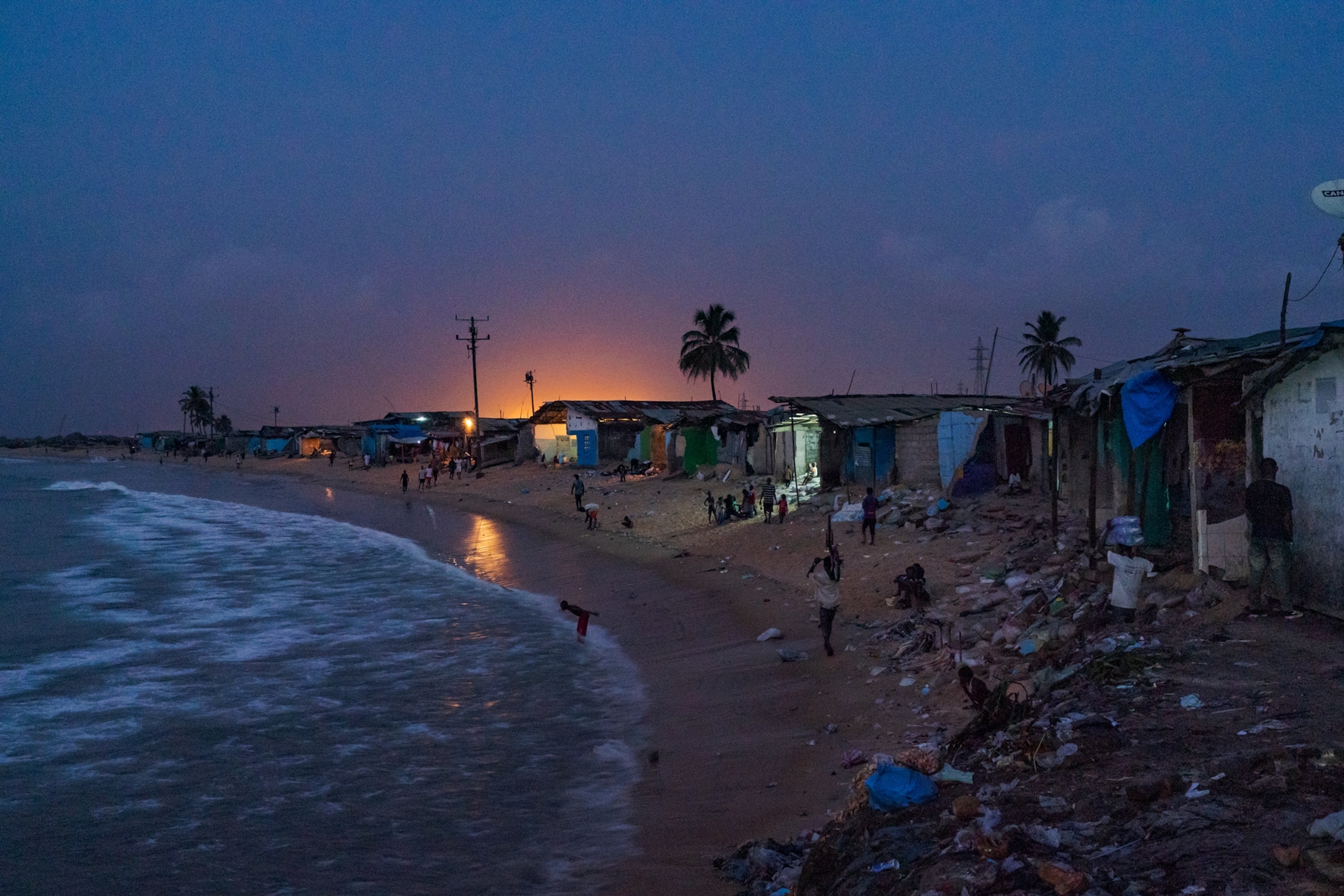 A crowded beach at dusk