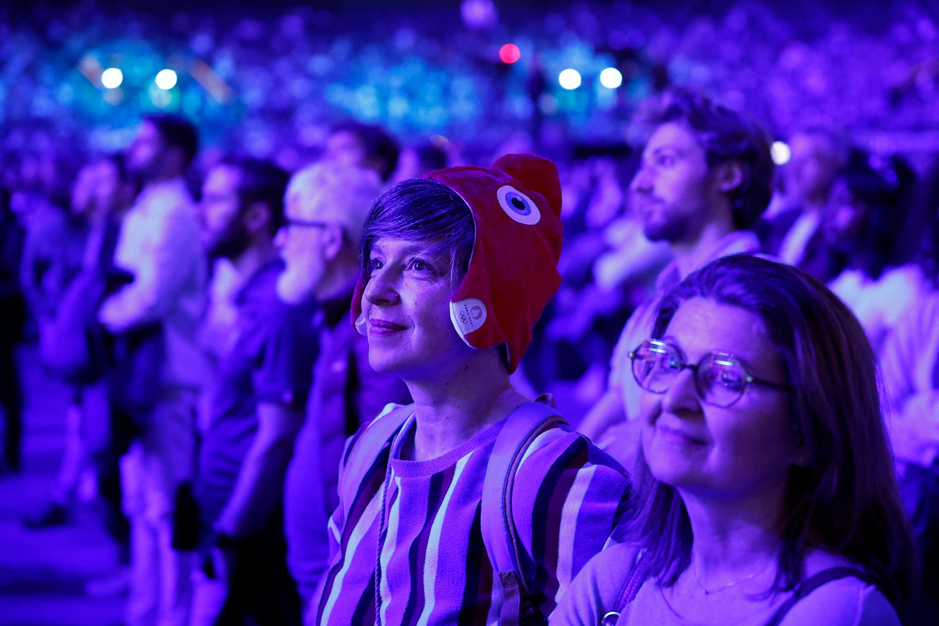 A participant wears a phrygian hat during the convention of volunteers for the Paris 2024 Olympic and Paralympic Games held at the Paris La Defense Arena in Nanterre.