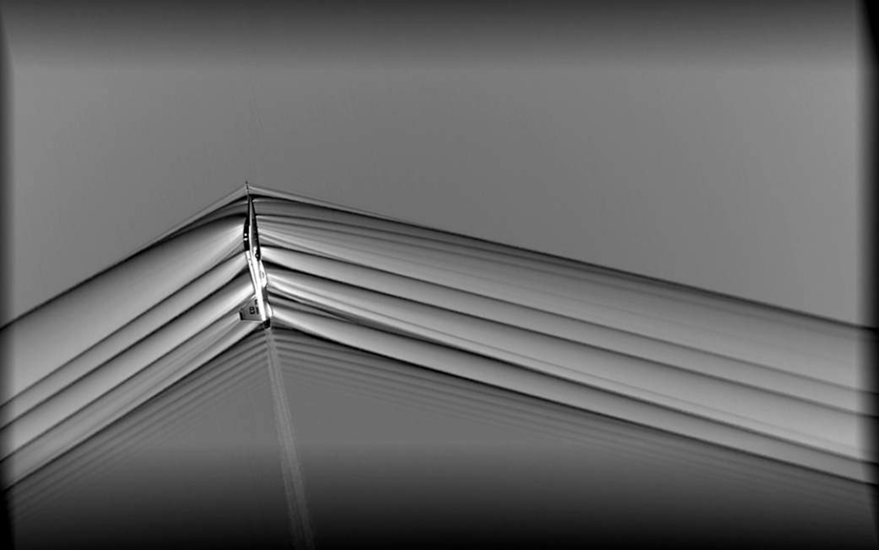 gray scale photo of jet and shockwaves.