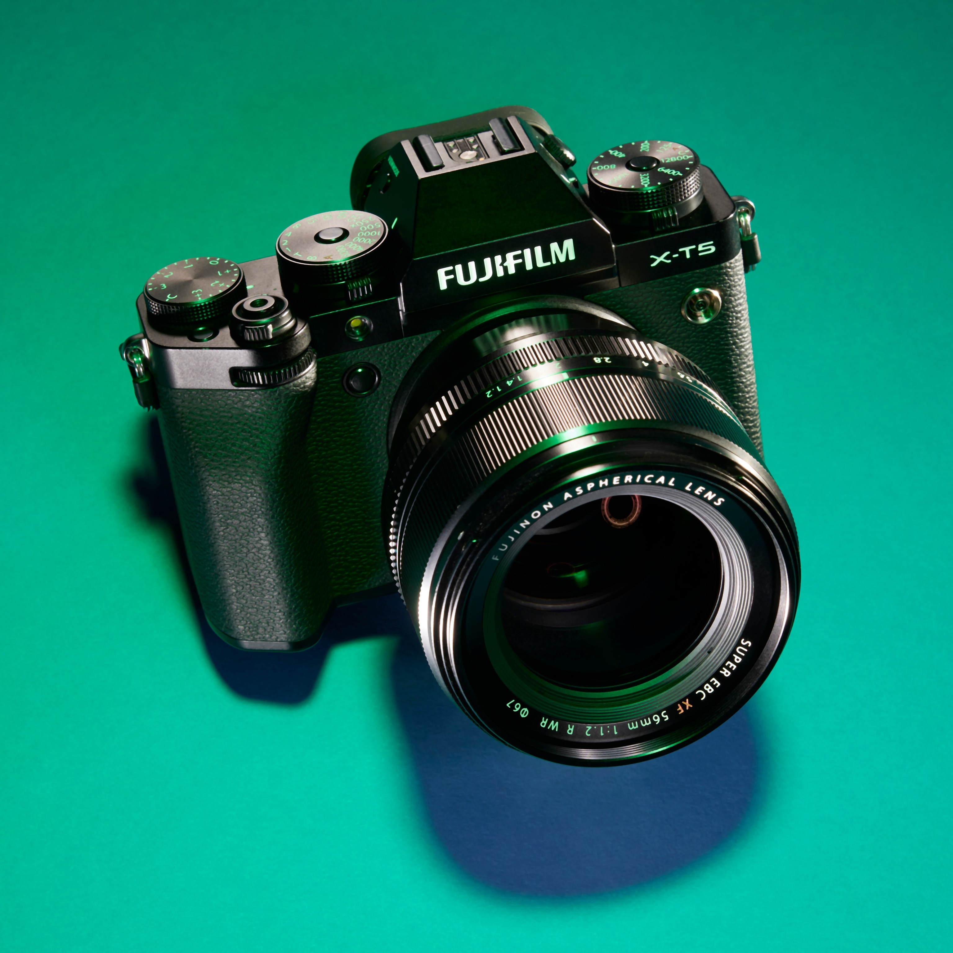 Studio photograph of the Fujifilm X-T5 against a green background