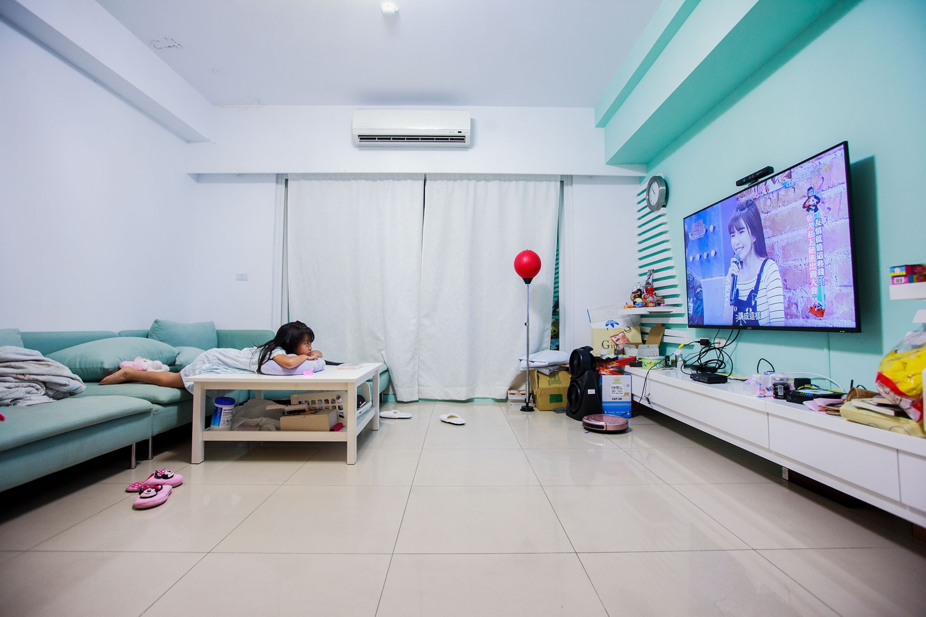 a young girl watching her mother on TV in Taiwan