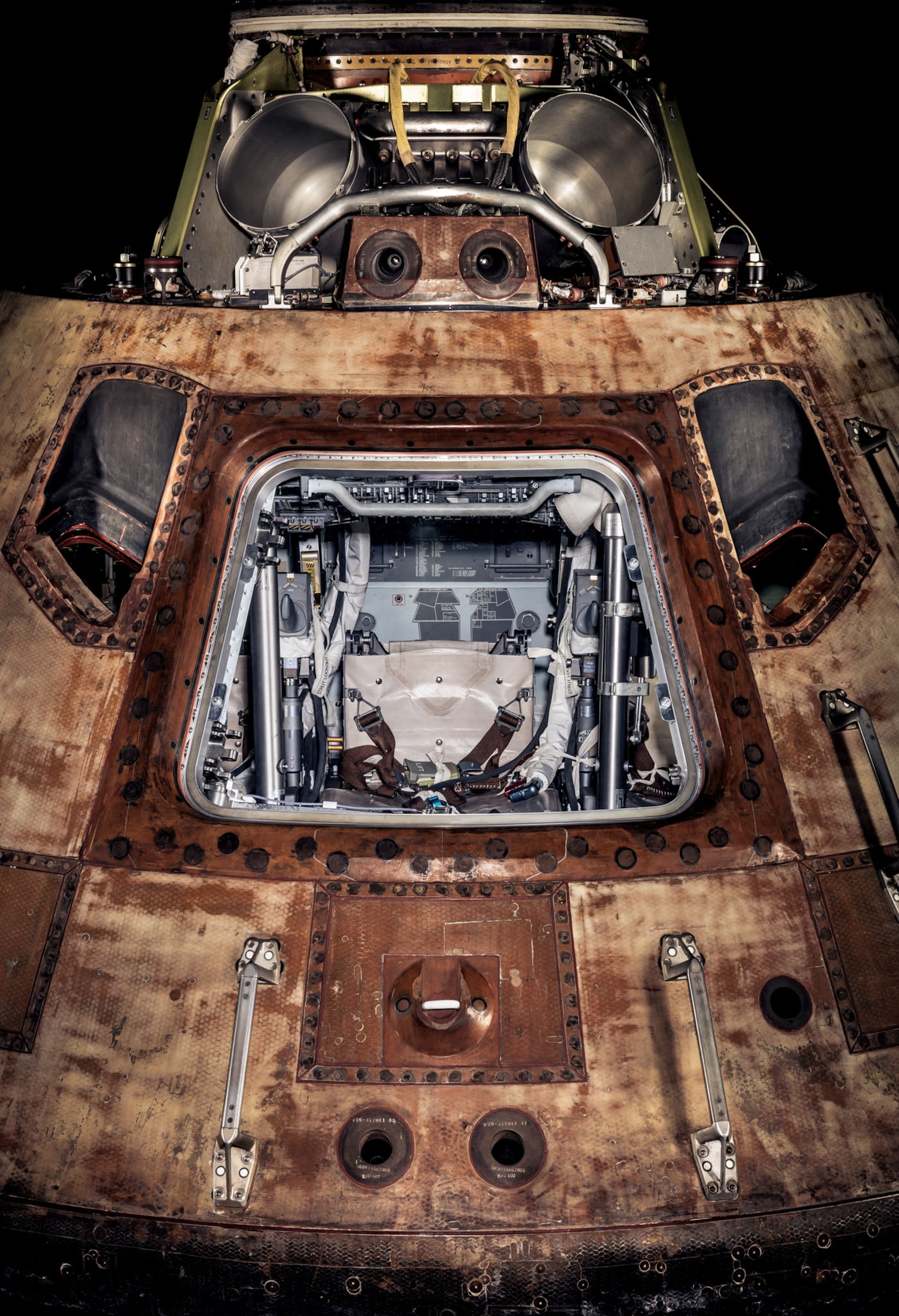 a rusted capsule with a window and a seat