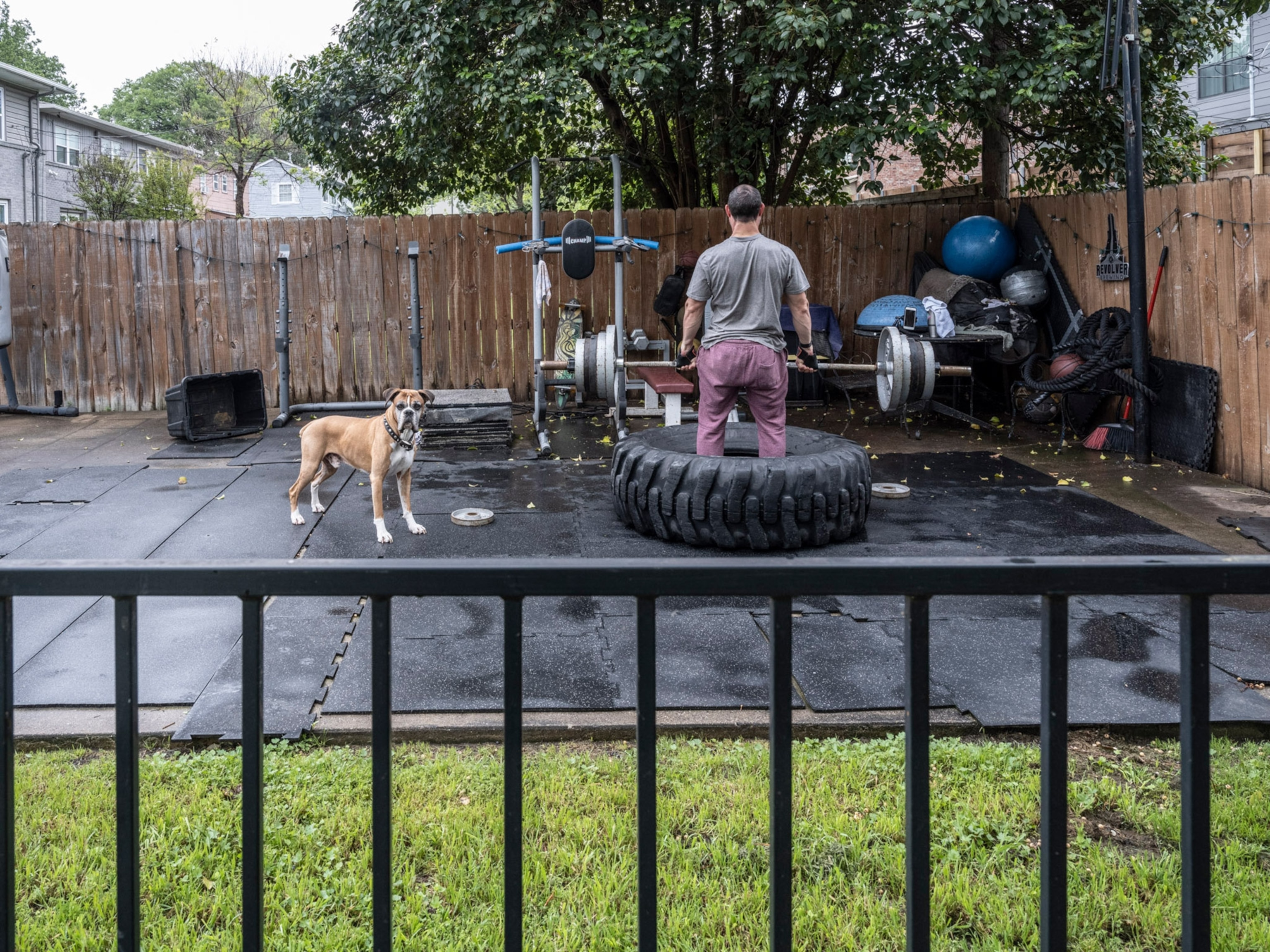 a person standing in a giant tire in an outdoor gym