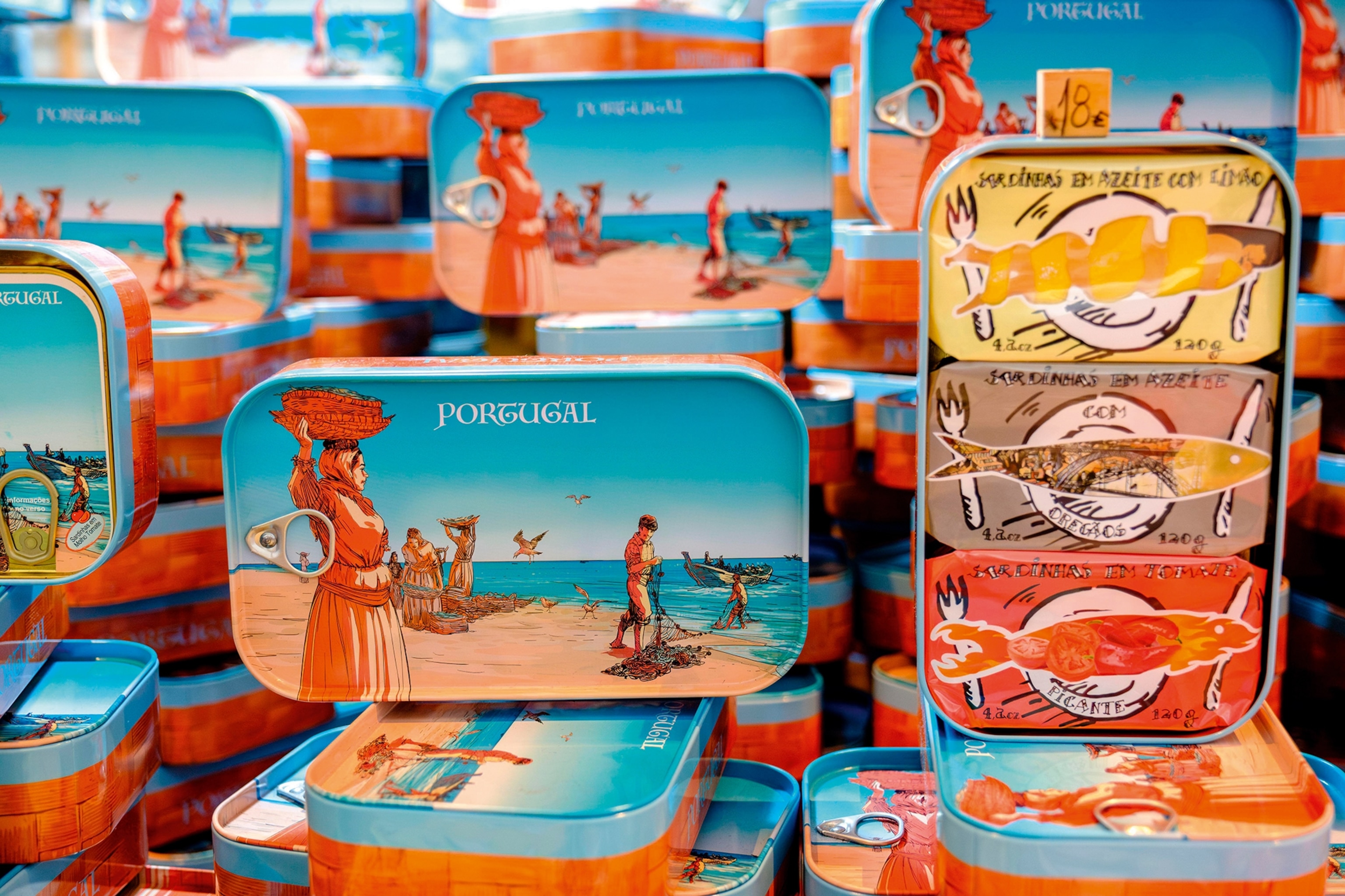 Stacked, colourful and illustrated sardine tins at a market stall.