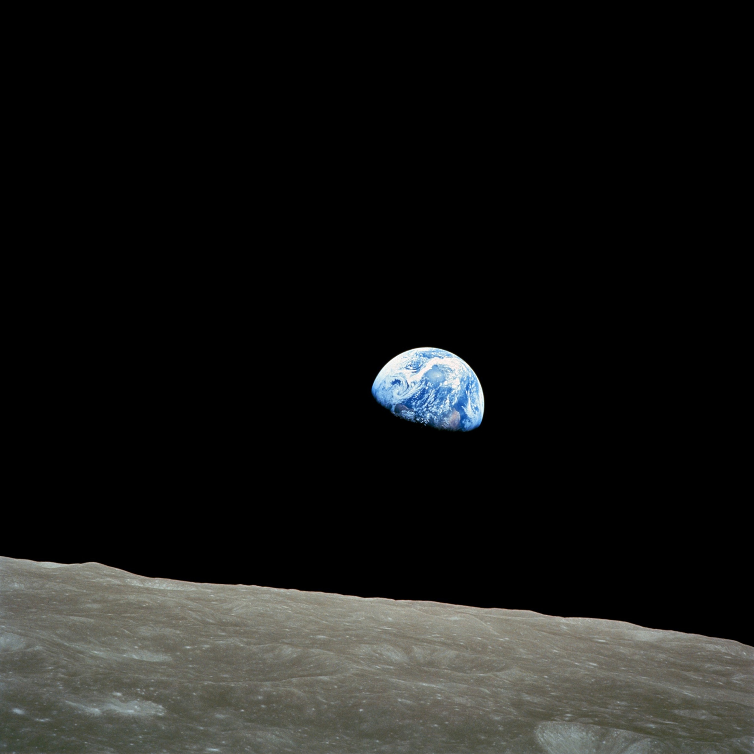 earth rising over the moon.