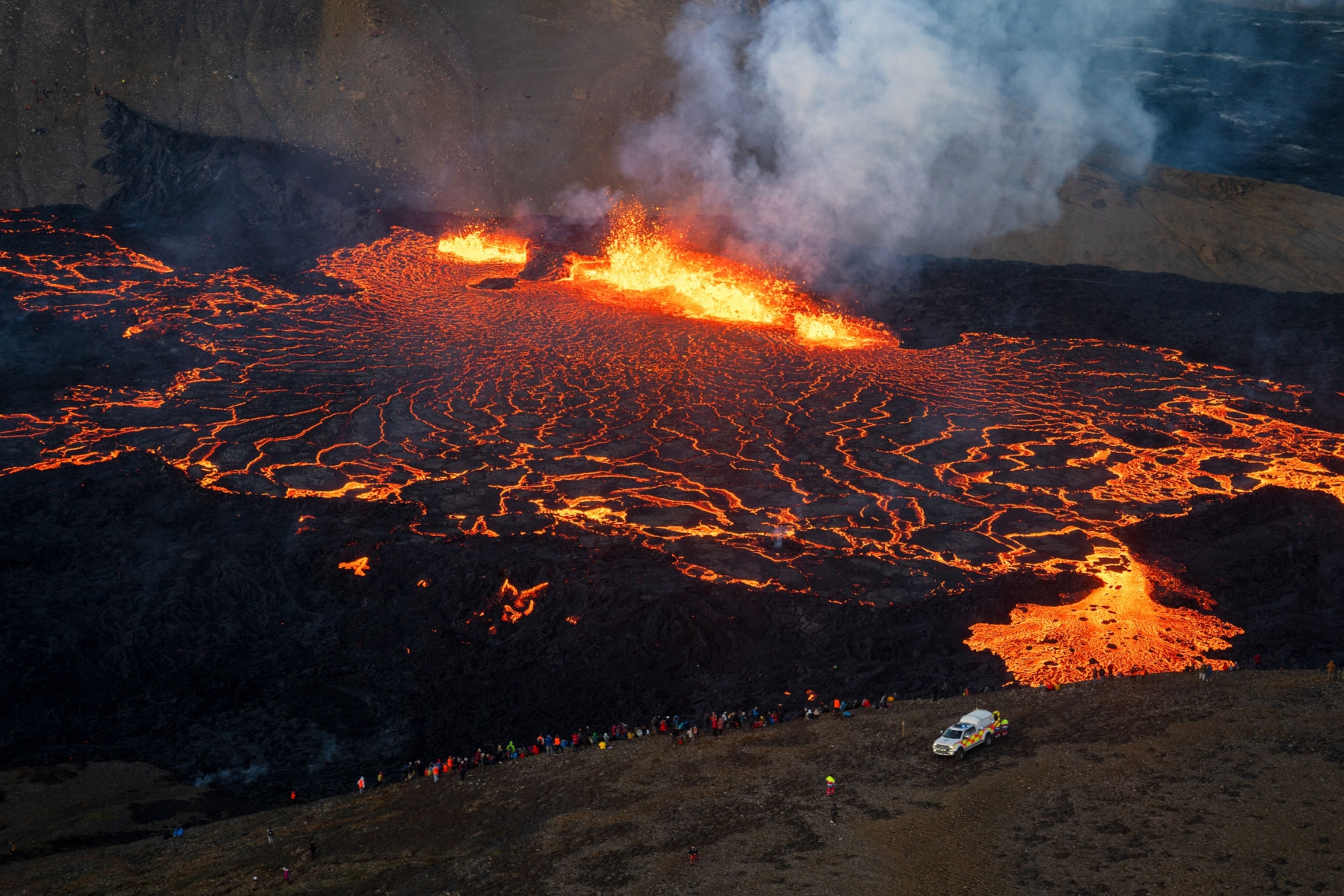 Tourists looking at the eruption