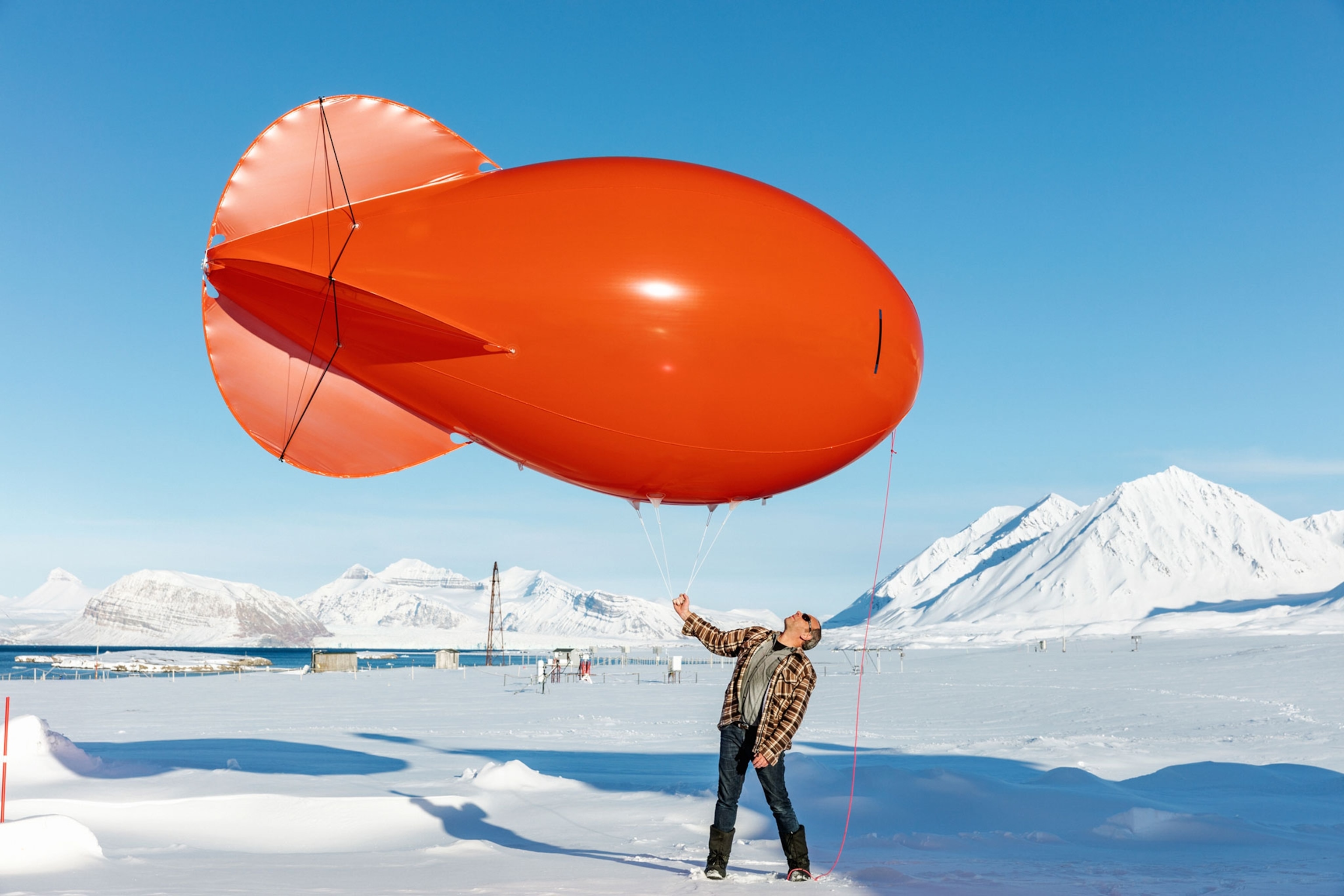 a scientist with a tethered balloon to measure the wind.