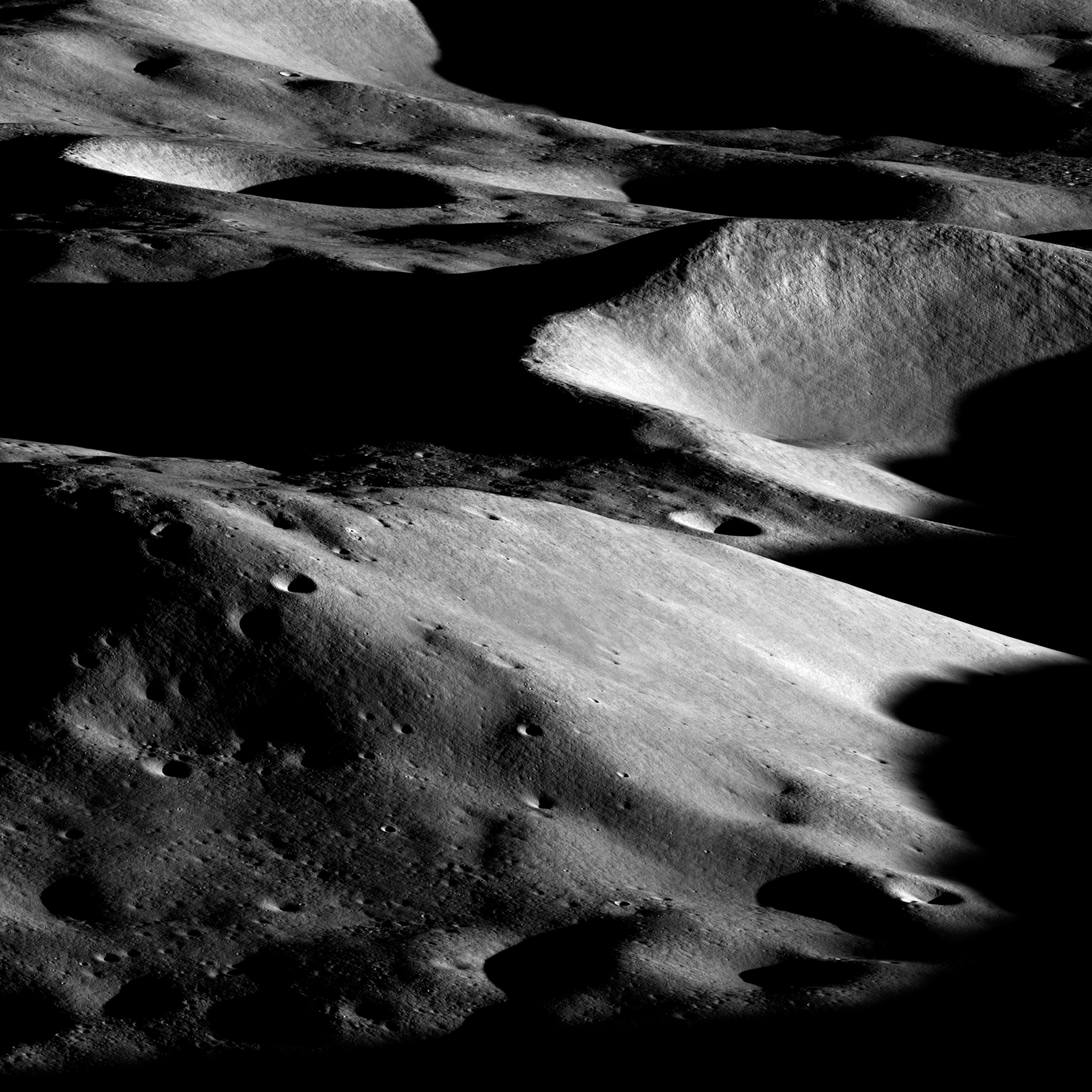 A black and white cratered landscape of the moon, showing a potential site to land Artemis 3.