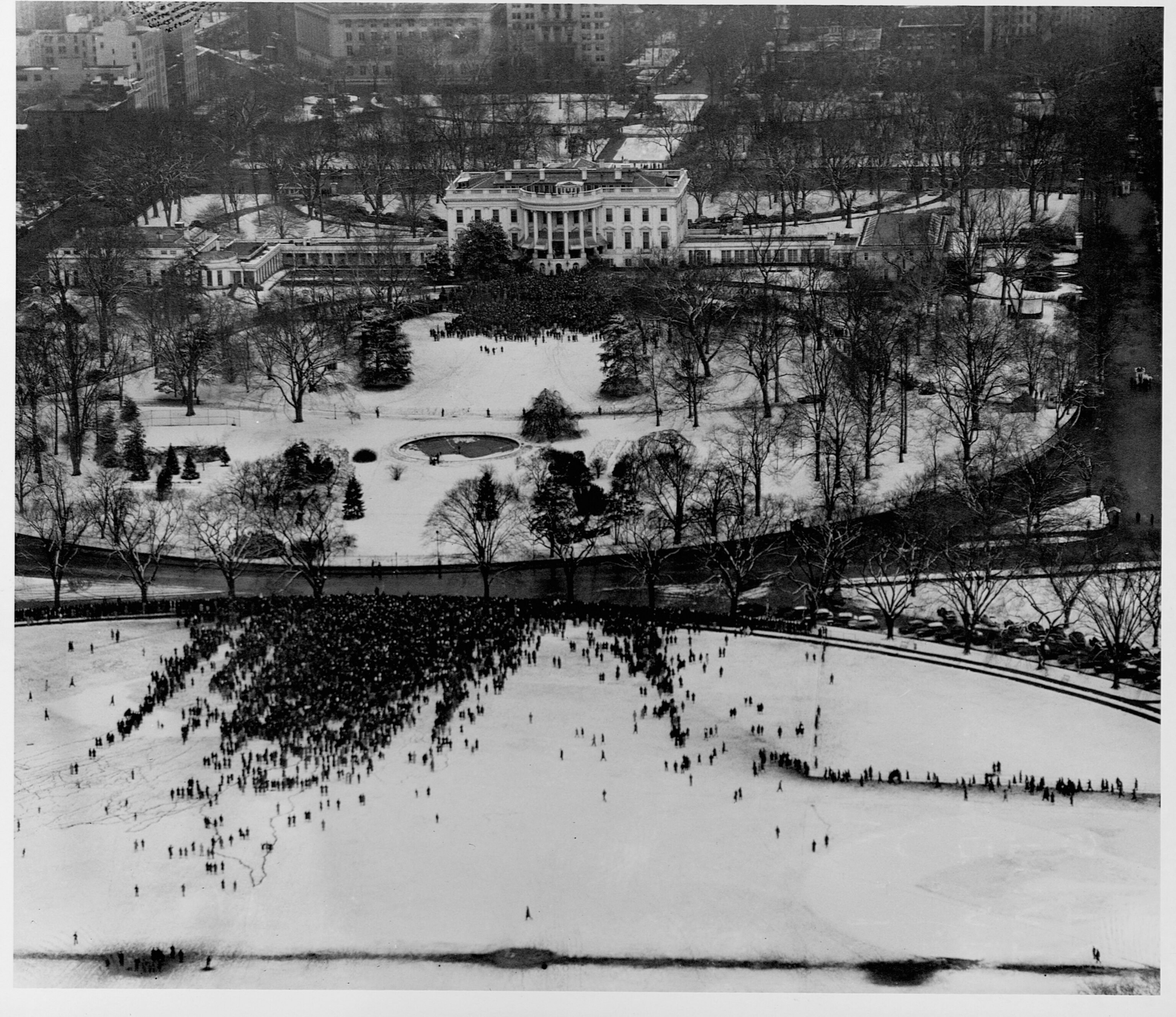 a view of crowds in front of the white house from above