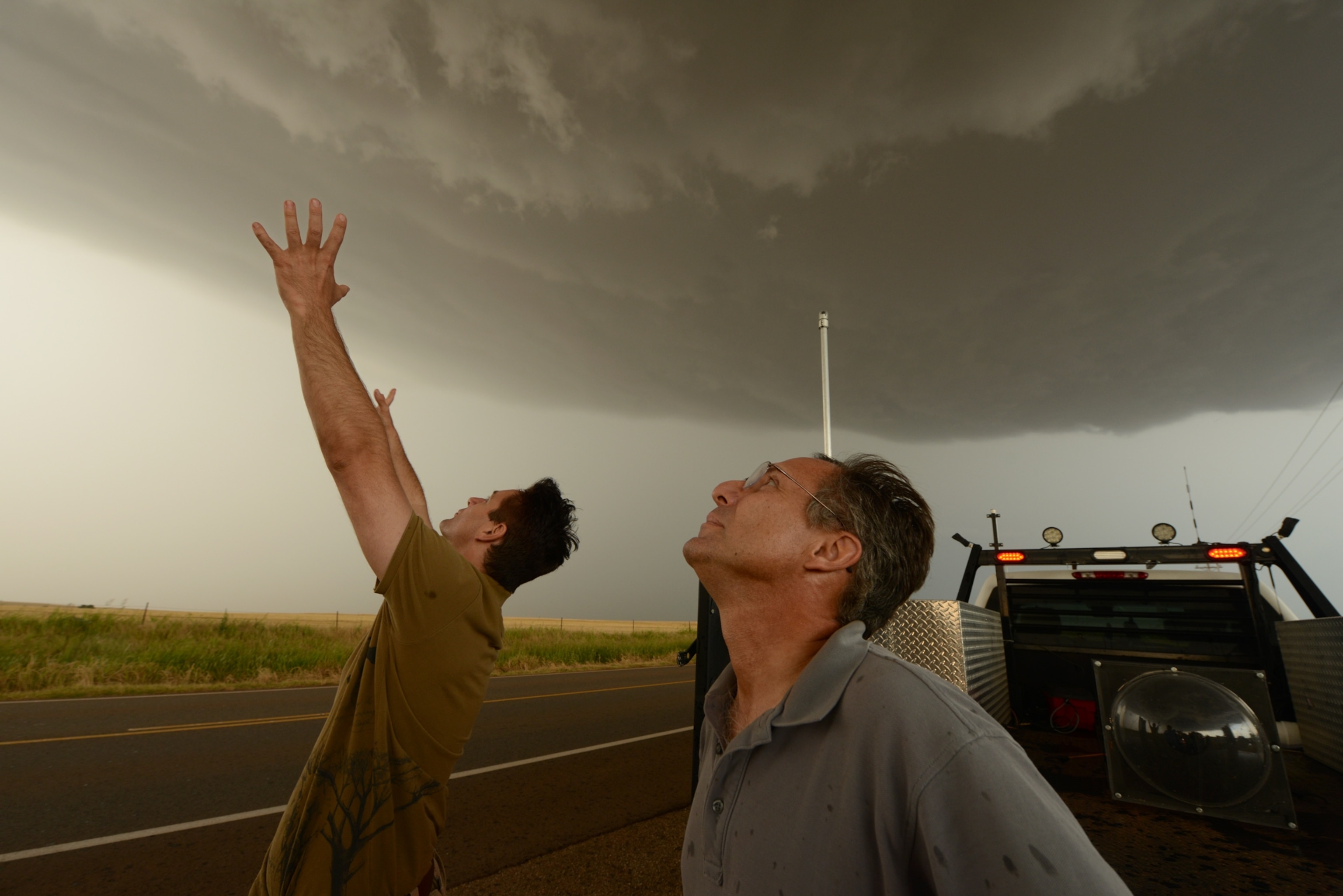 Tim Samaras and Carl Young looking up at a supercell thunderstorm in Oklahoma
