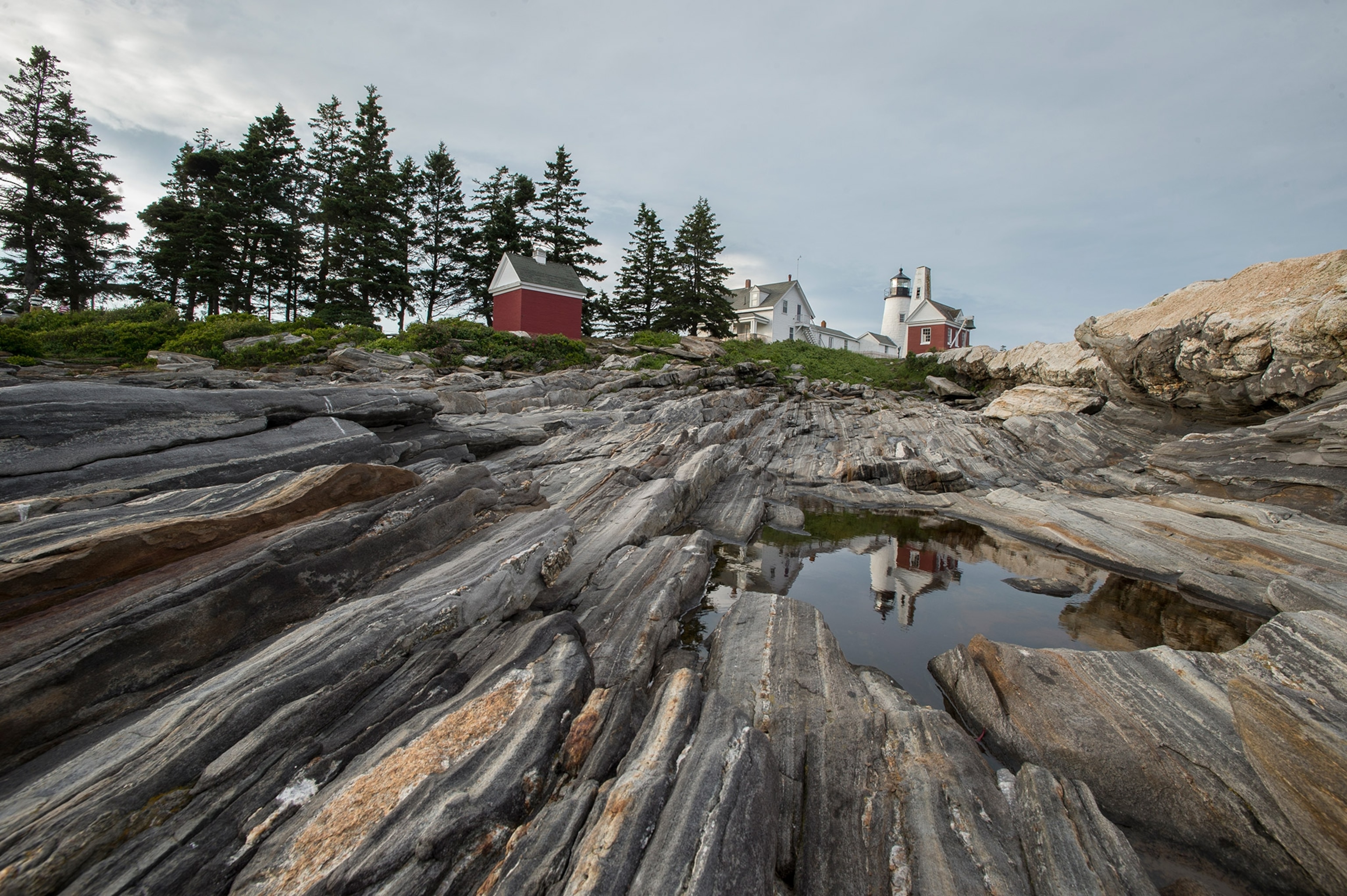 Pemaquid Point Lighthouse and its rocky shoreline in Pemaquid, Maine