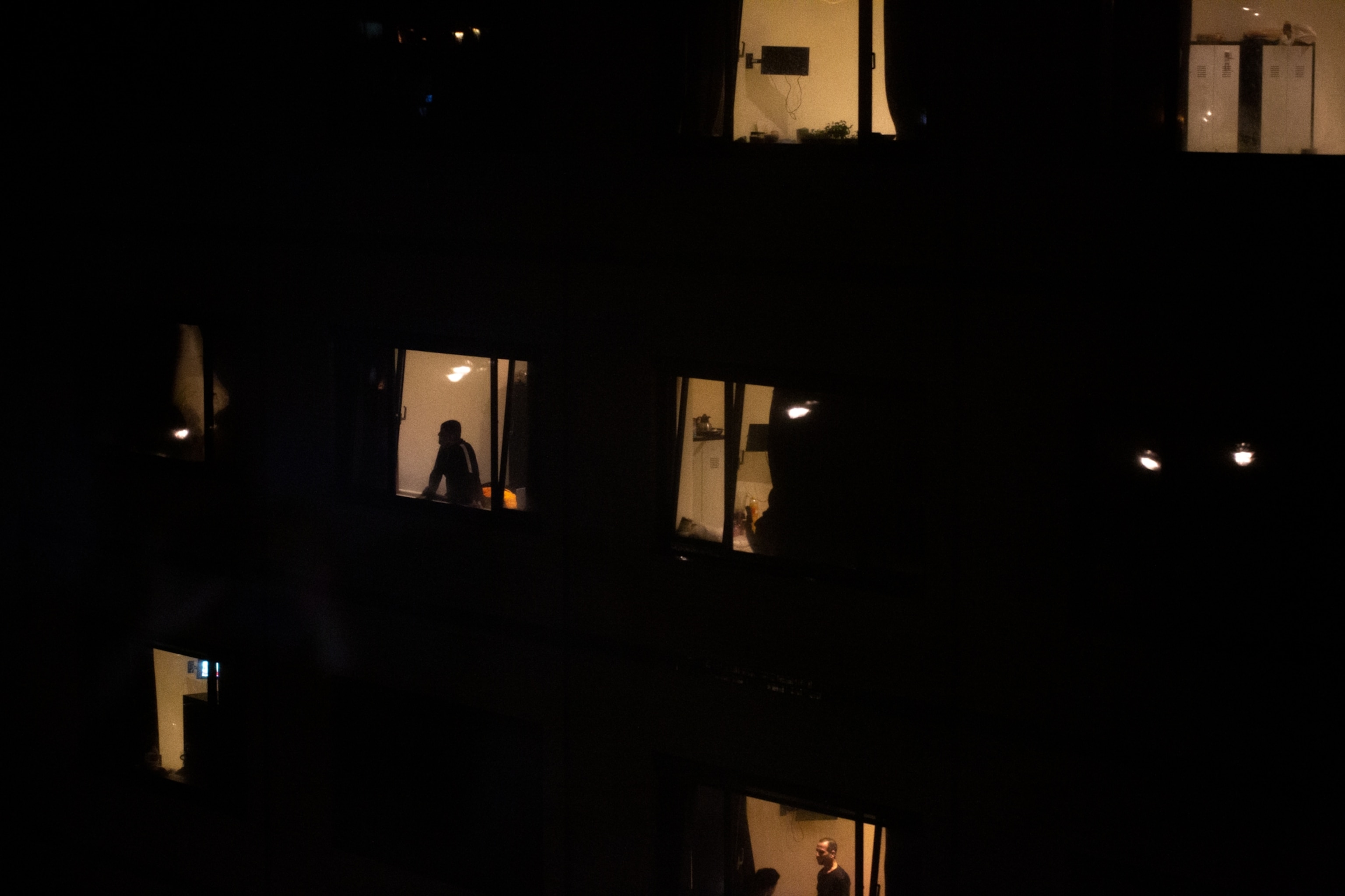 a view from one apartment window looking toward a group of other apartment windows