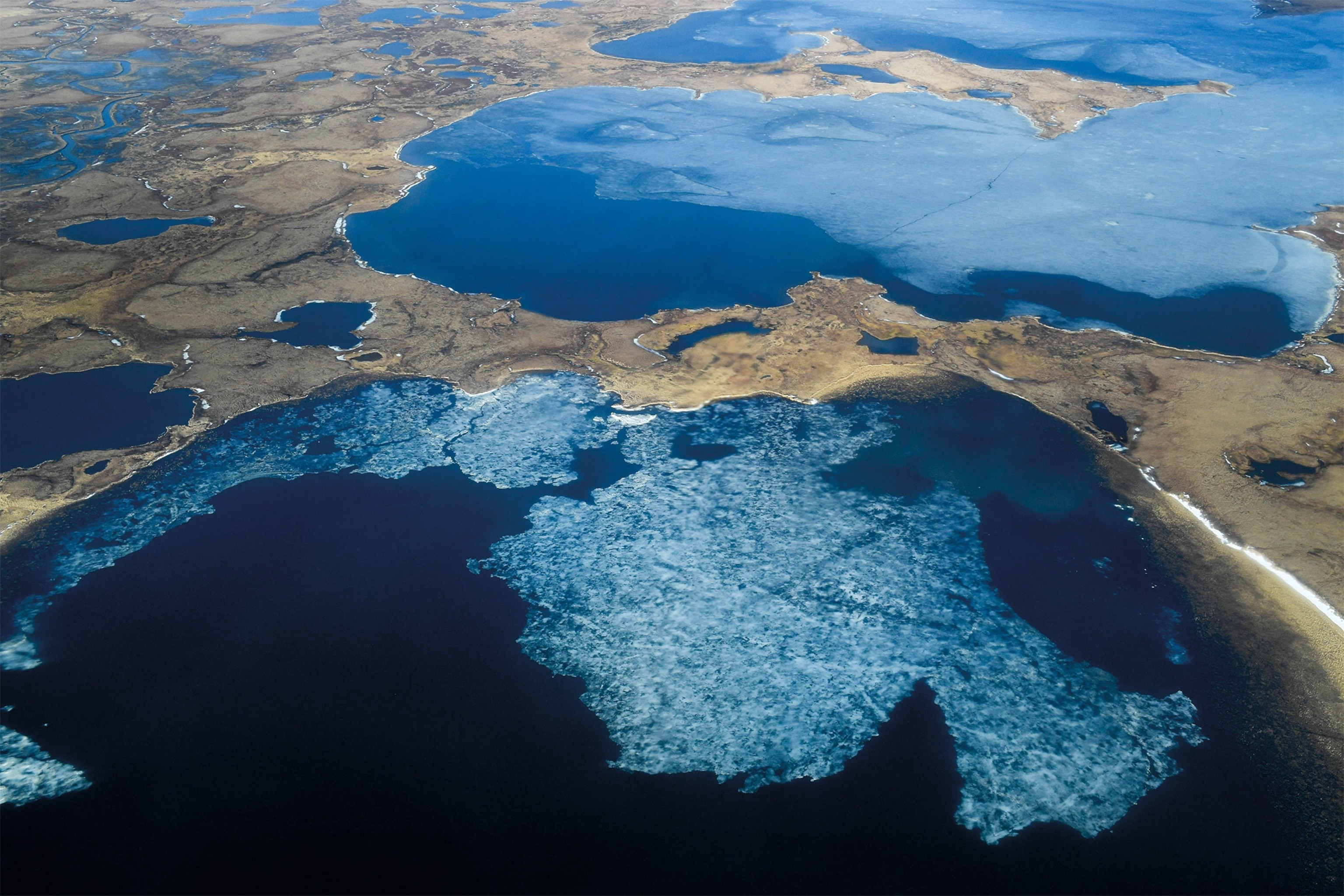 A 2019 aerial view of the Yup’ik village of Quinhagak, Alaska, reveals thawing permafrost and thinning ice. Scientists say Alaska is warming faster than any other U.S. state.