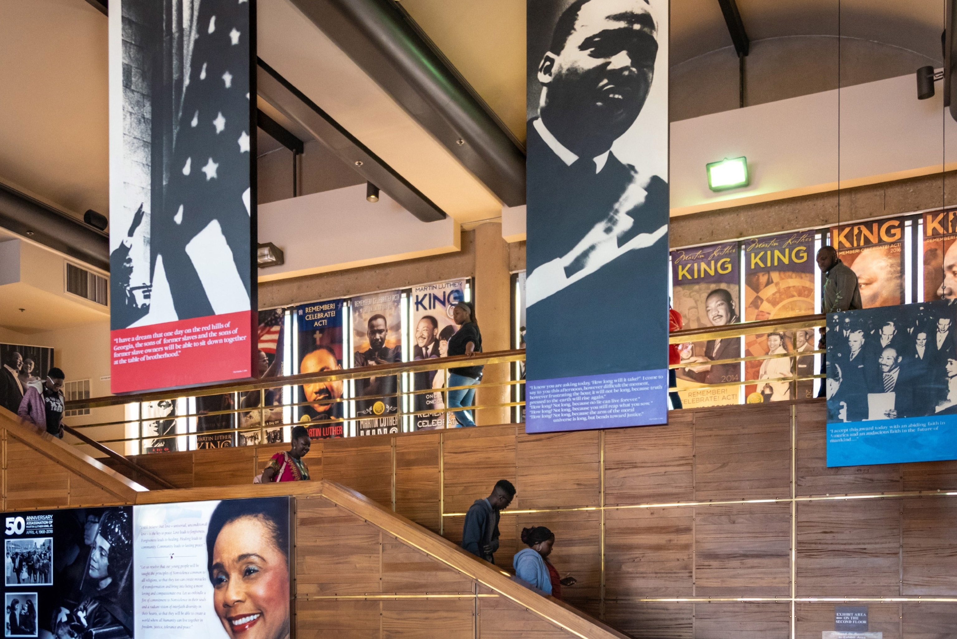 People walk down the stairs at the Freedom Hall at The King Center in Atlanta