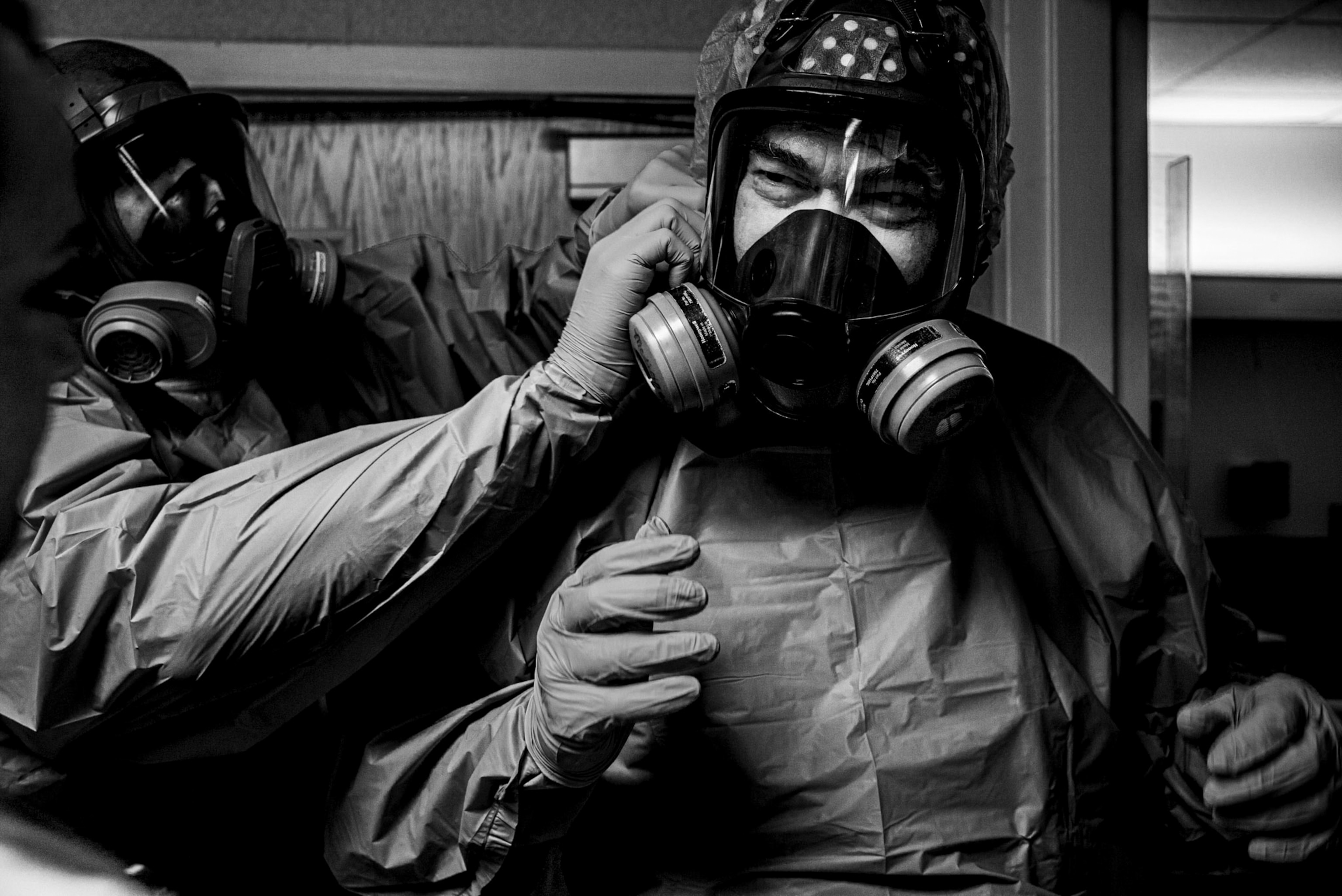 A doctor puts on a full-face protective mask