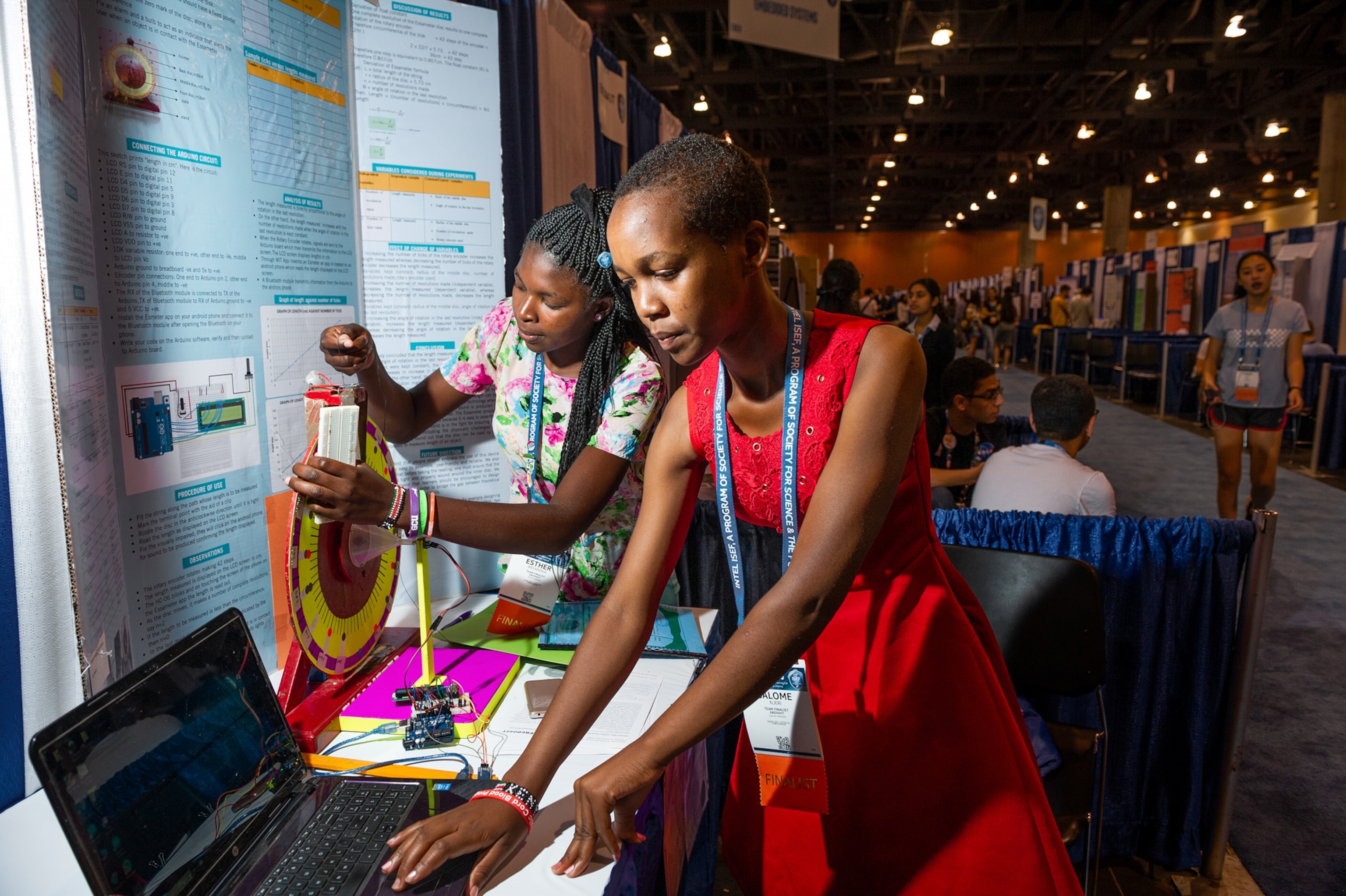 two women working on their science fair station