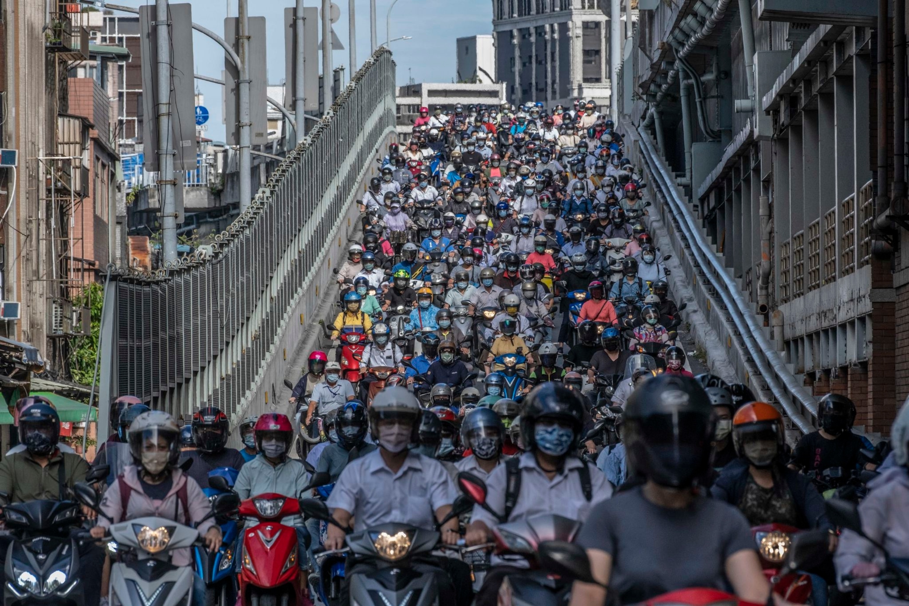 A roadway is packed to the brim with people on motorbikes