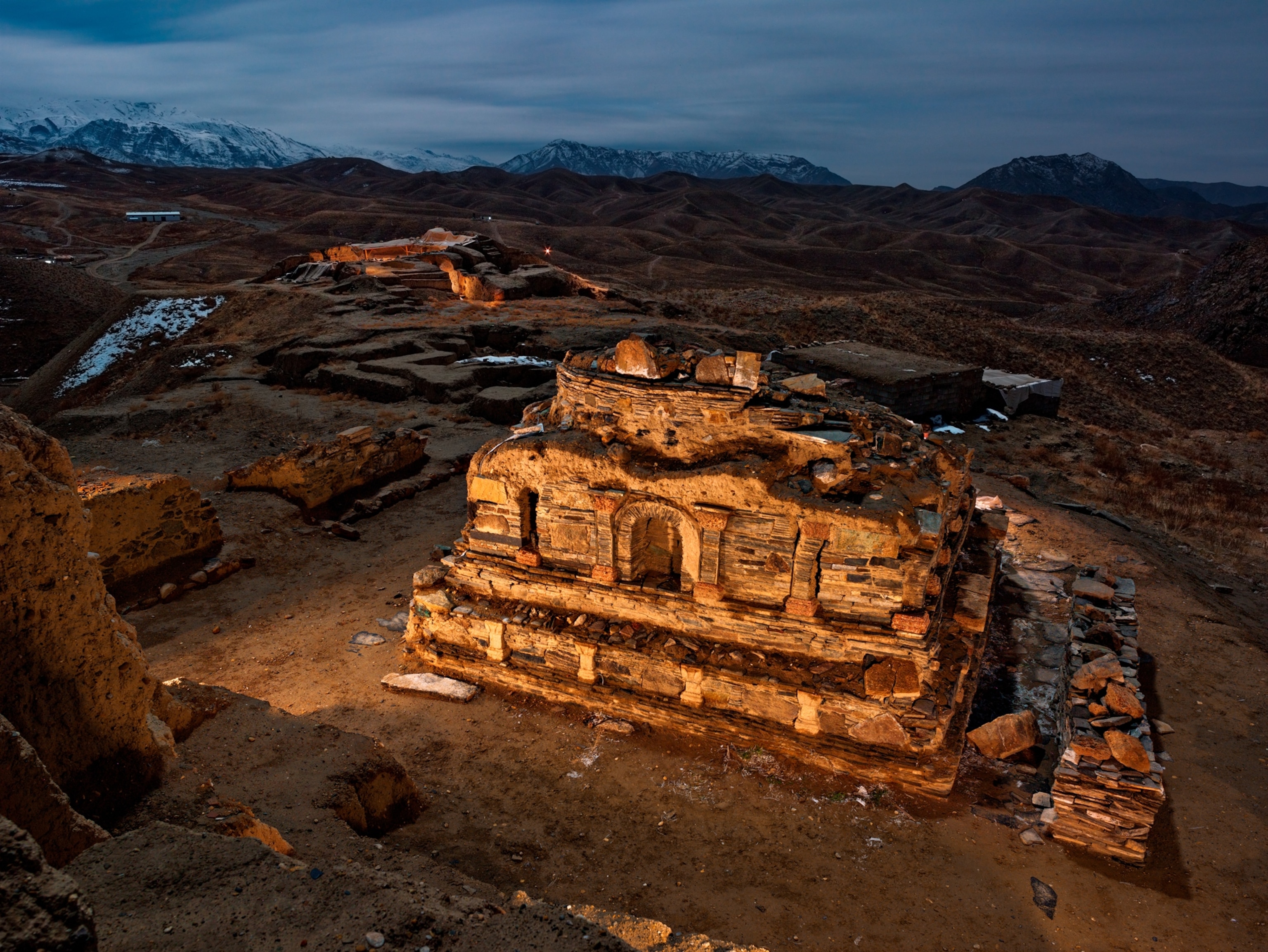 Picture of stone structure lit in dusk.