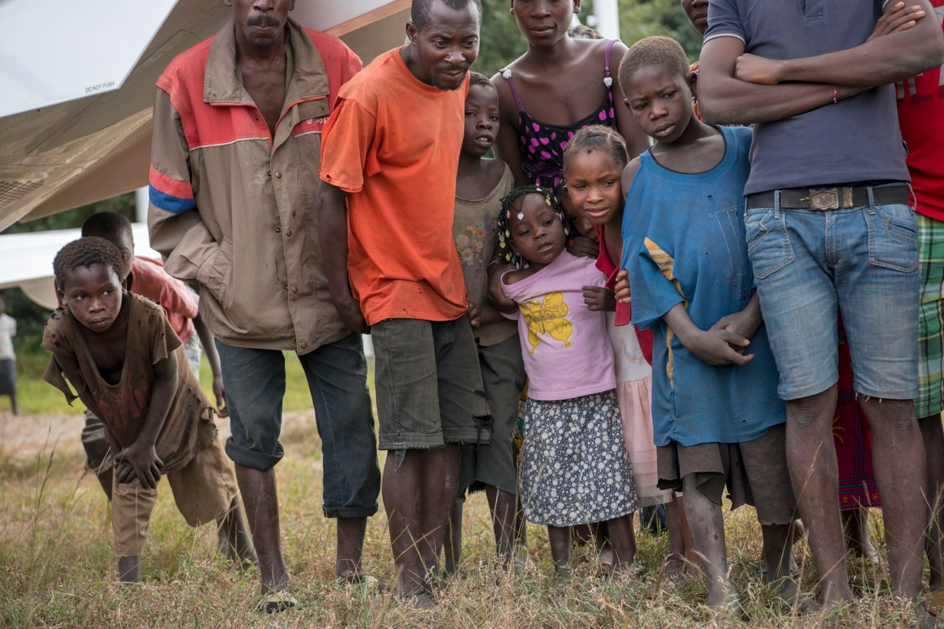 villagers watching the arrival of a sedated lion