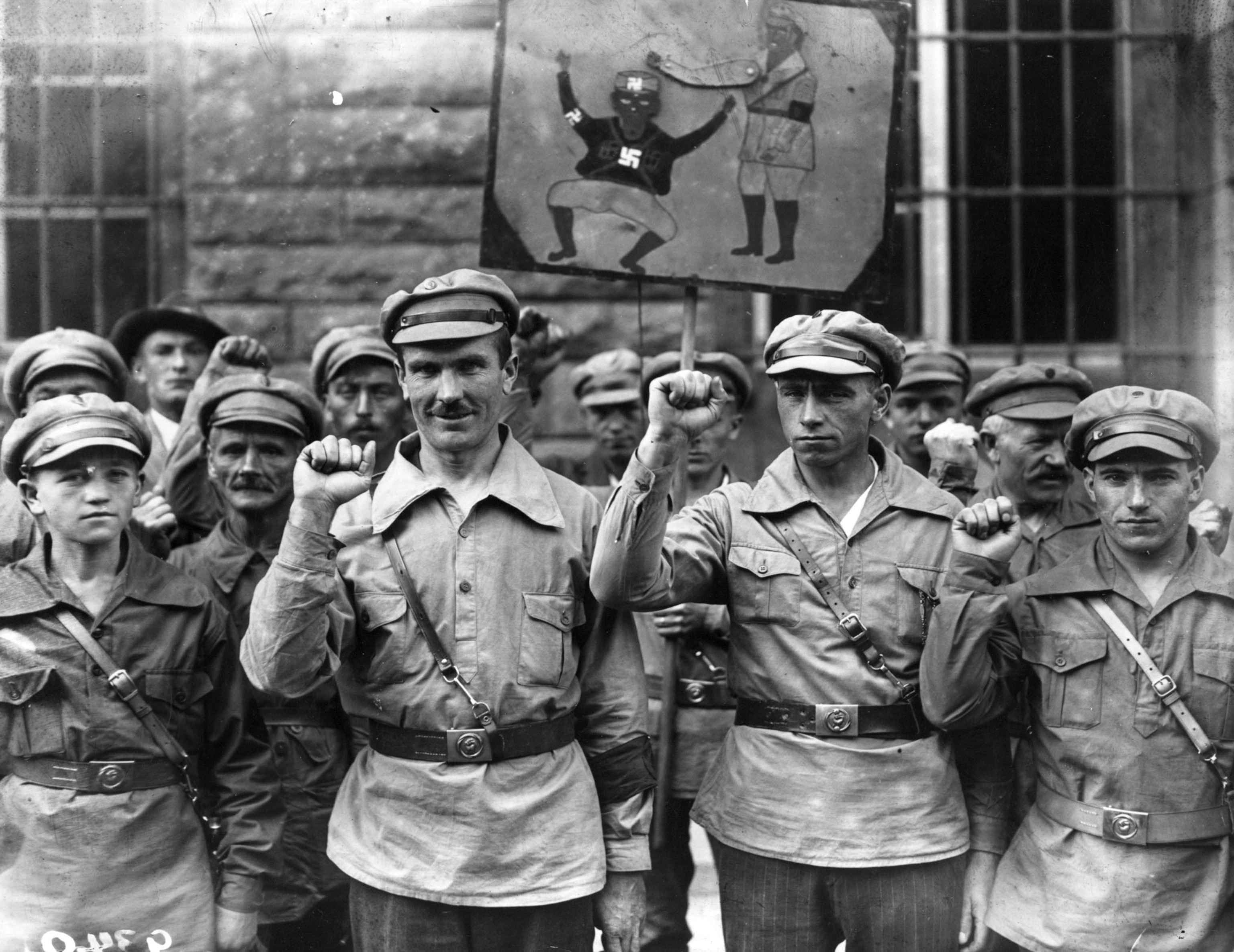 An old black and white picture of Germans raising their fists