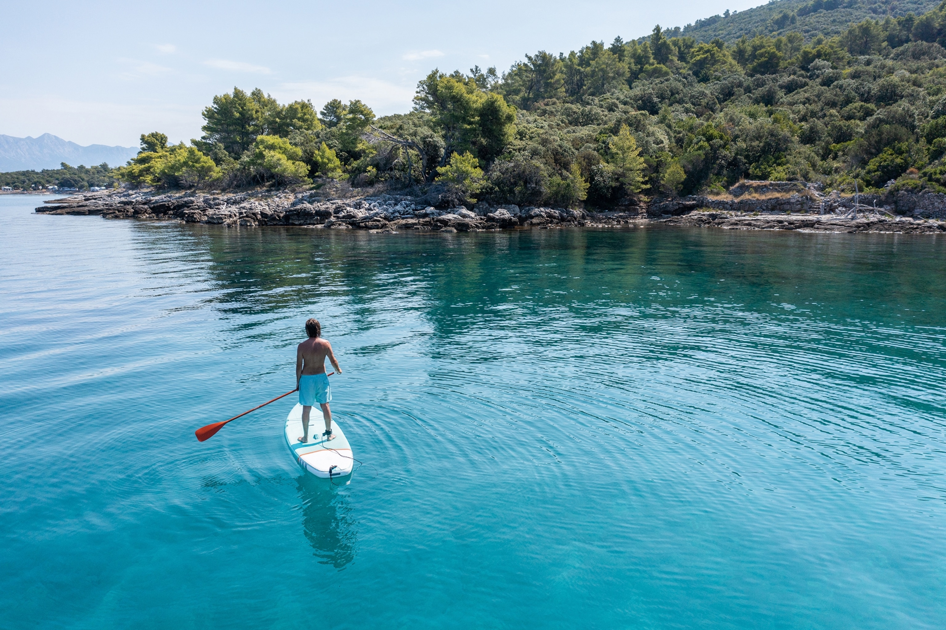 Person on a stand-up paddleboard in Croatia.