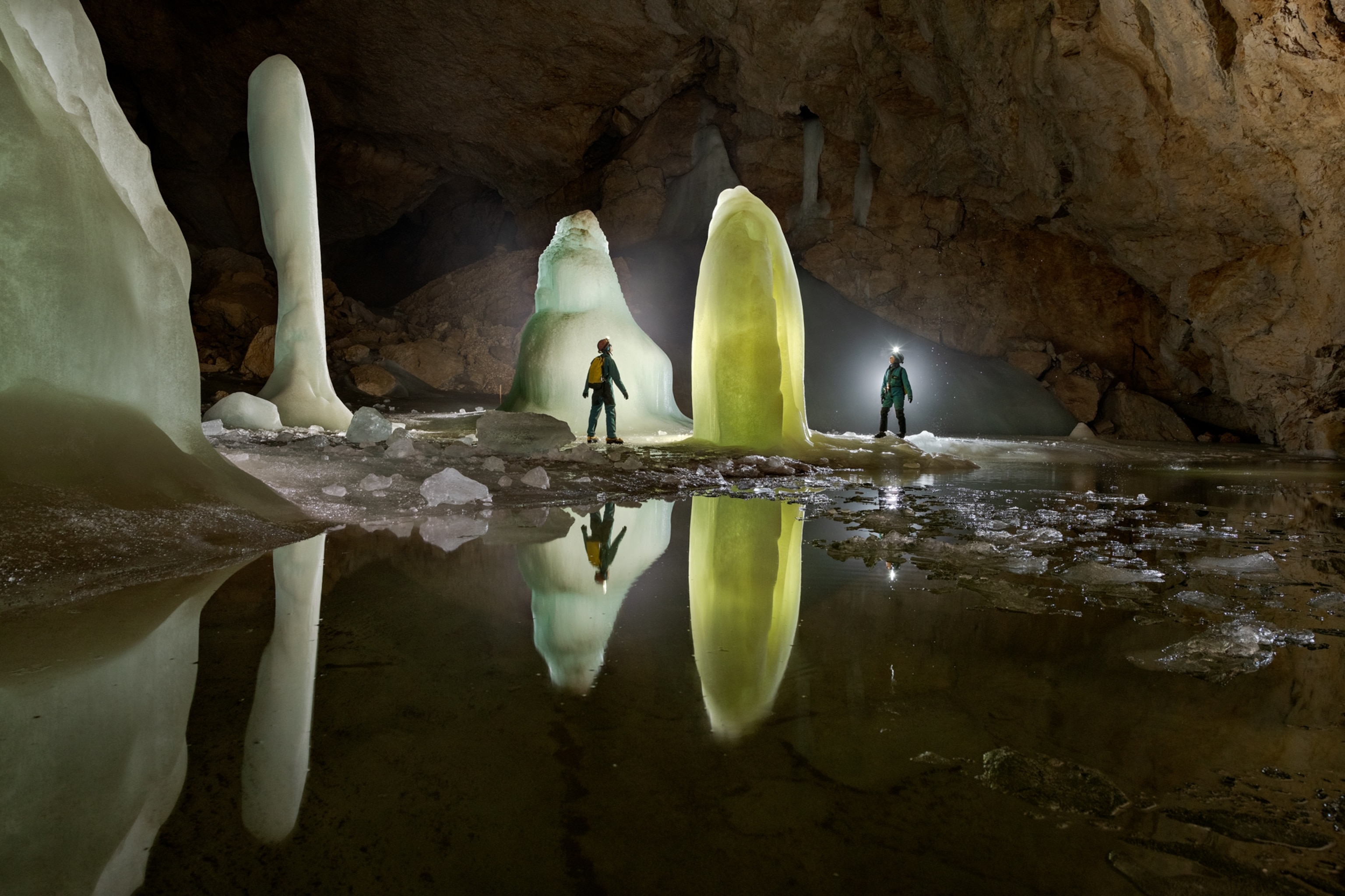 Picture of ice cones lit with yellow neon light.