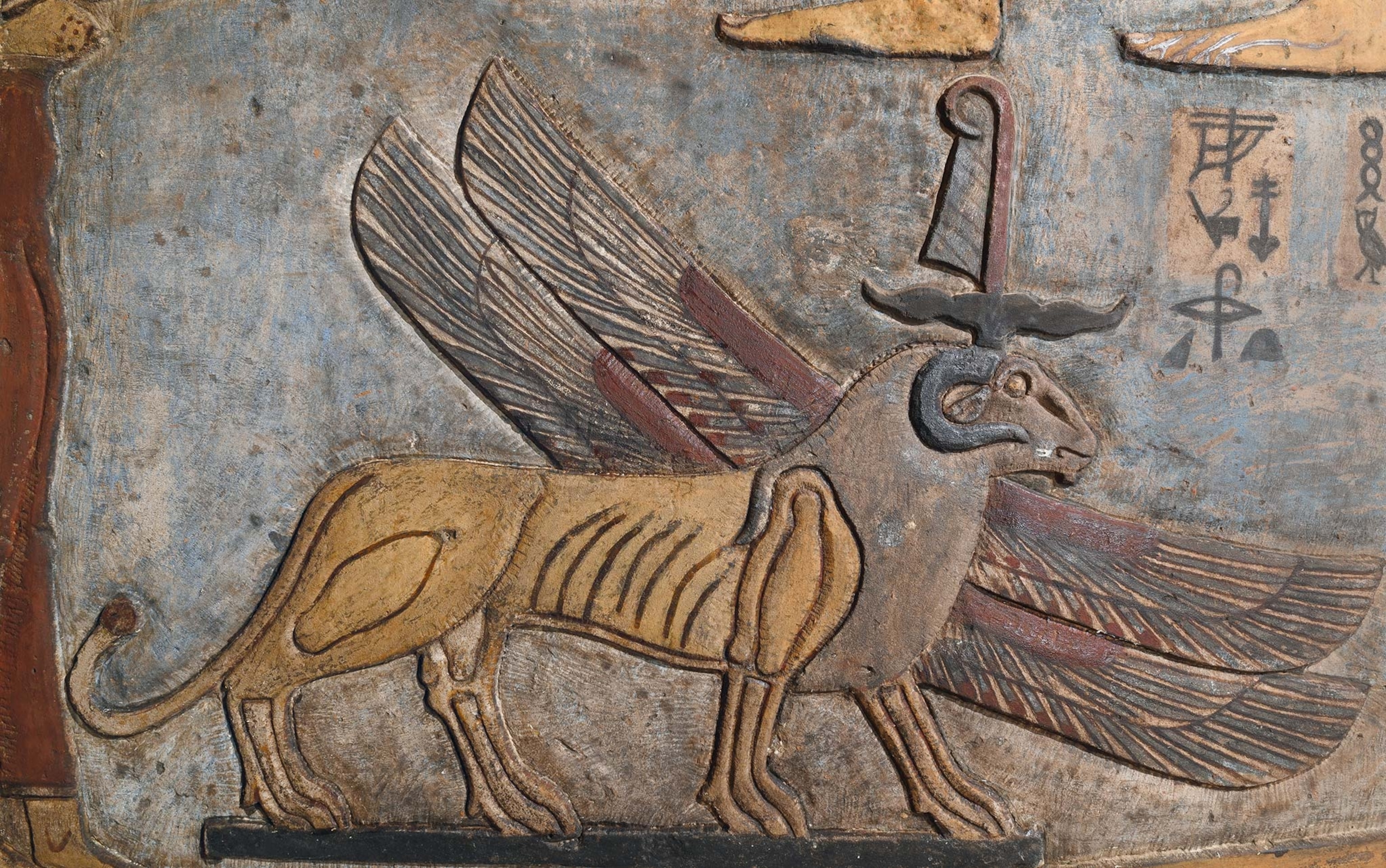 A restored and uncovered carving of a winged lion with a ram's head