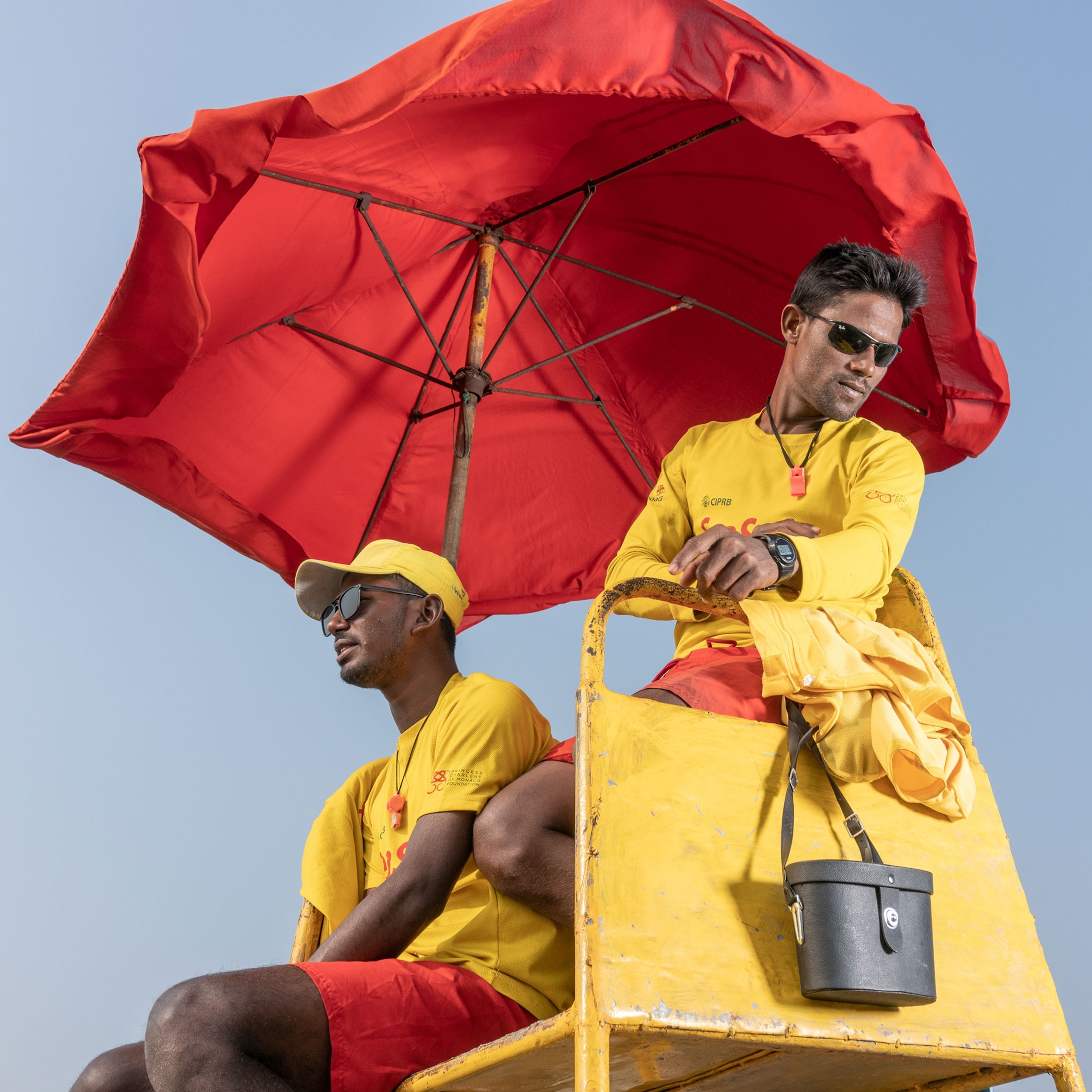 Picture of two lifeguards dressed in yellow and red.