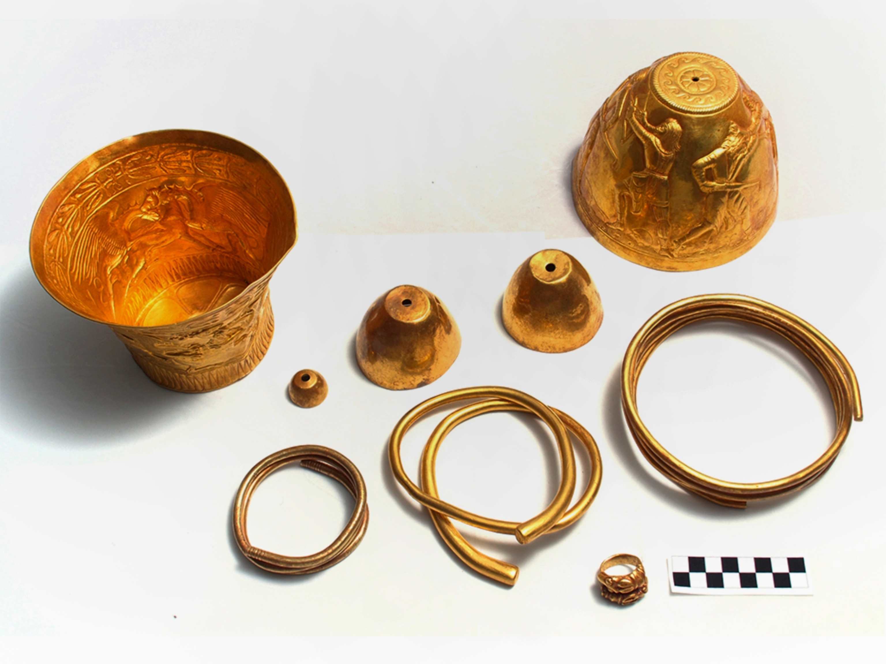 three gold cups, a heavy gold finger ring, two neck rings, and a gold bracelet