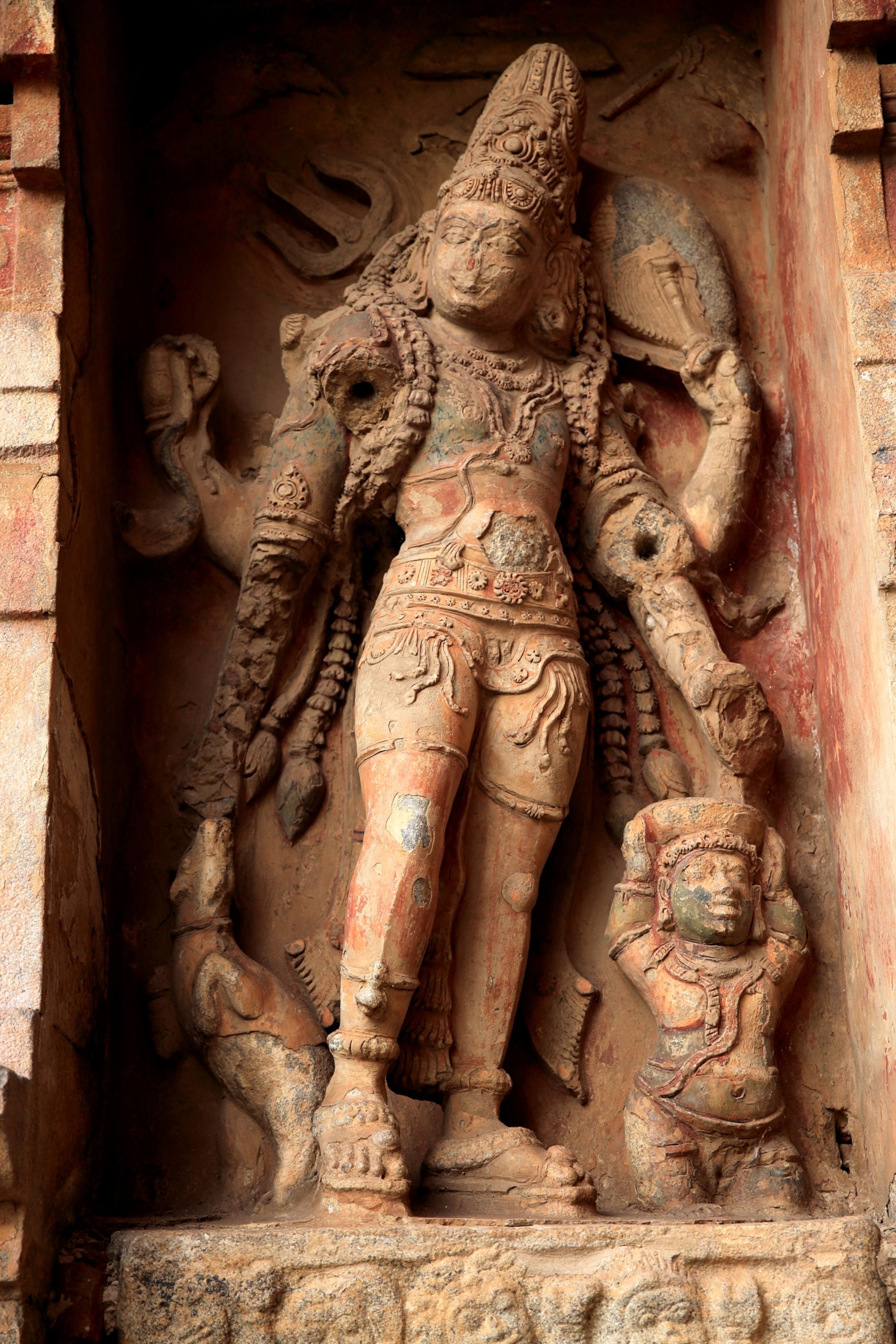 Multi-armed human like figure holds various objects