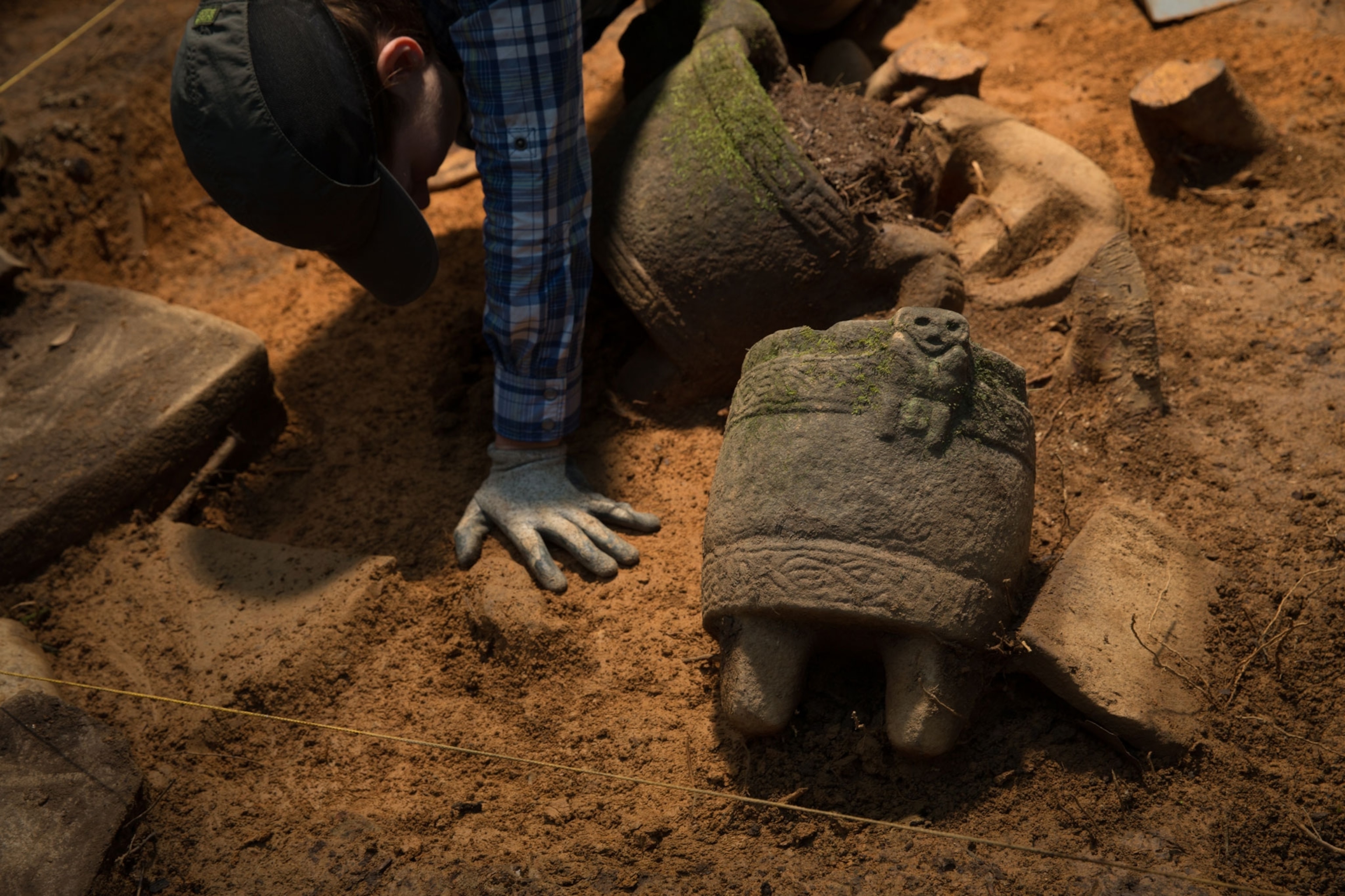 An archeologist works on the cache of artifacts recovered during an excavation of an ancient city in Honduras.