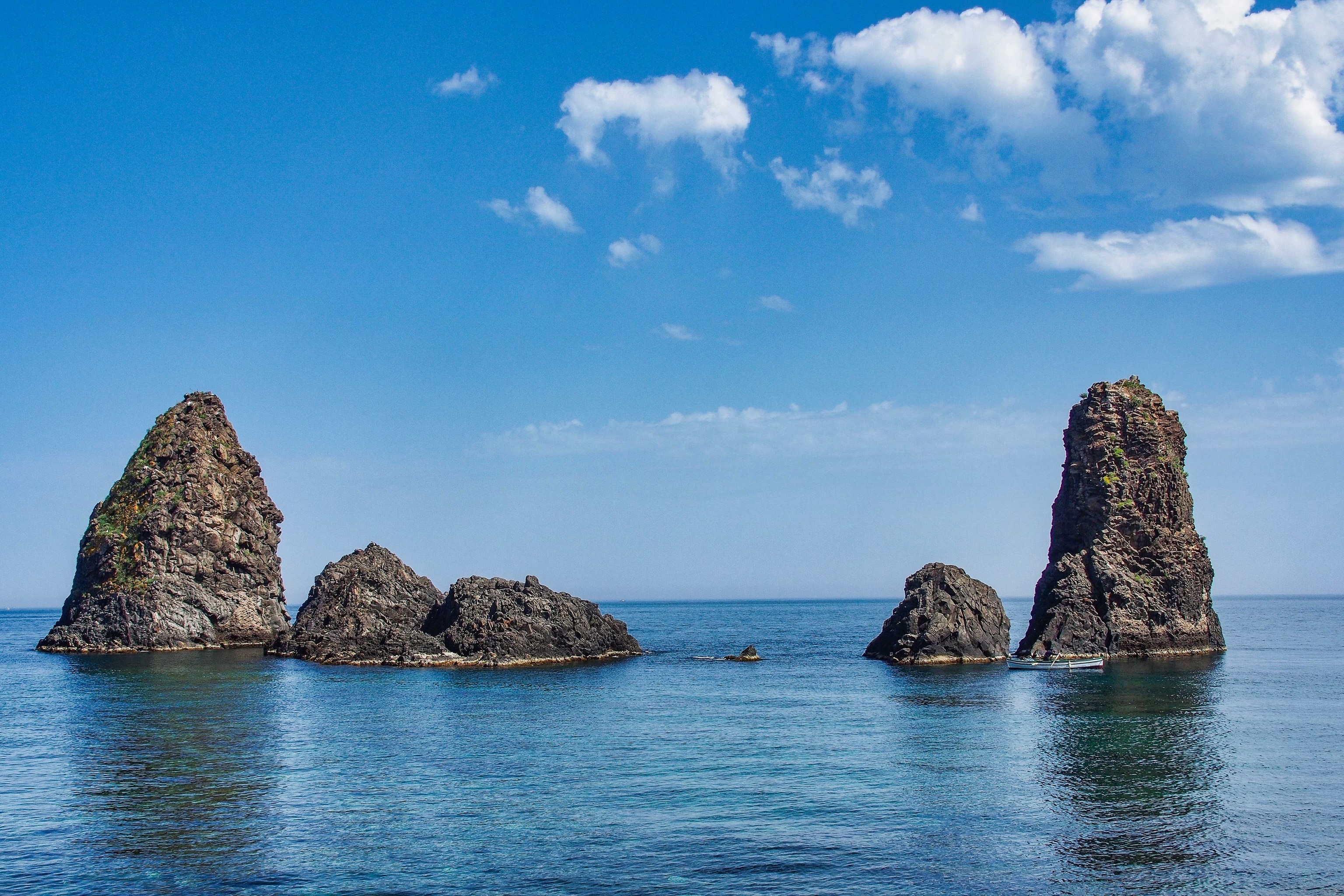 Four rugged rocks in clear blue sea