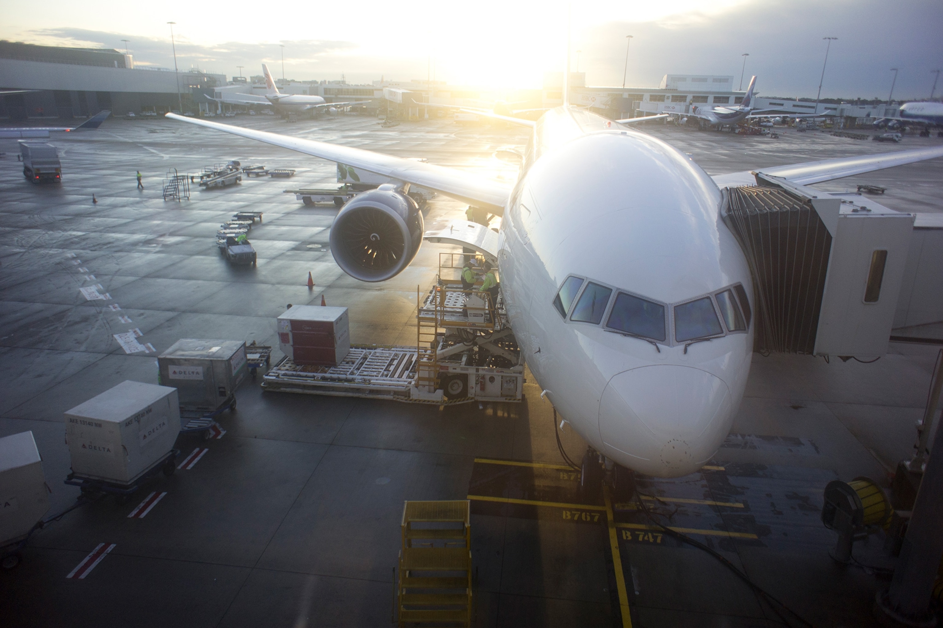 A jet at an airport terminal gate.