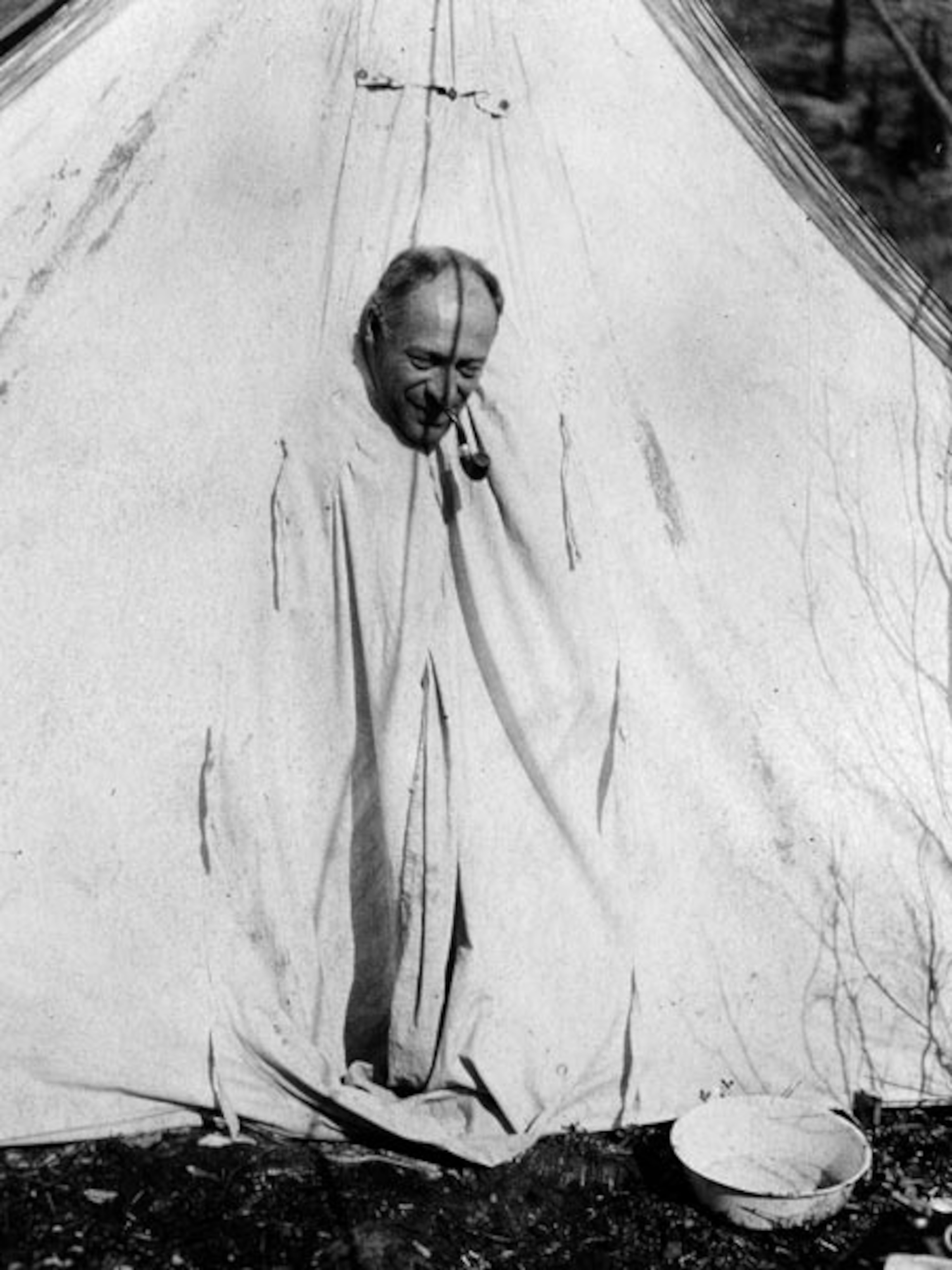 A doctor fumigates all but his head inside a formaldehyde tent