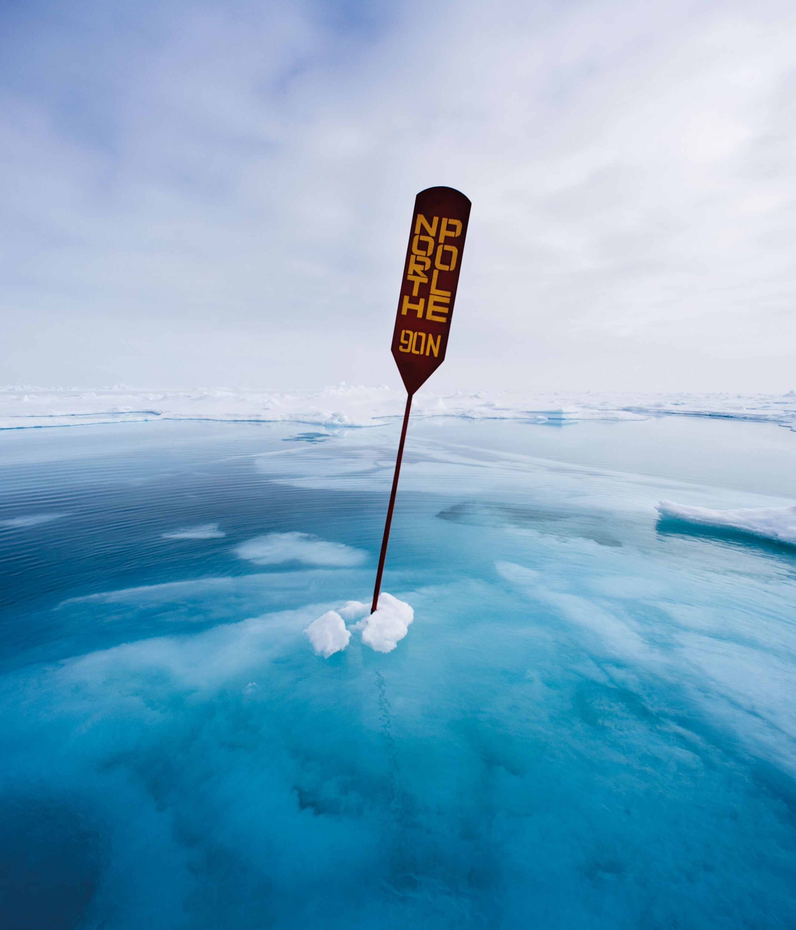 a sign marks the 90° north latitude