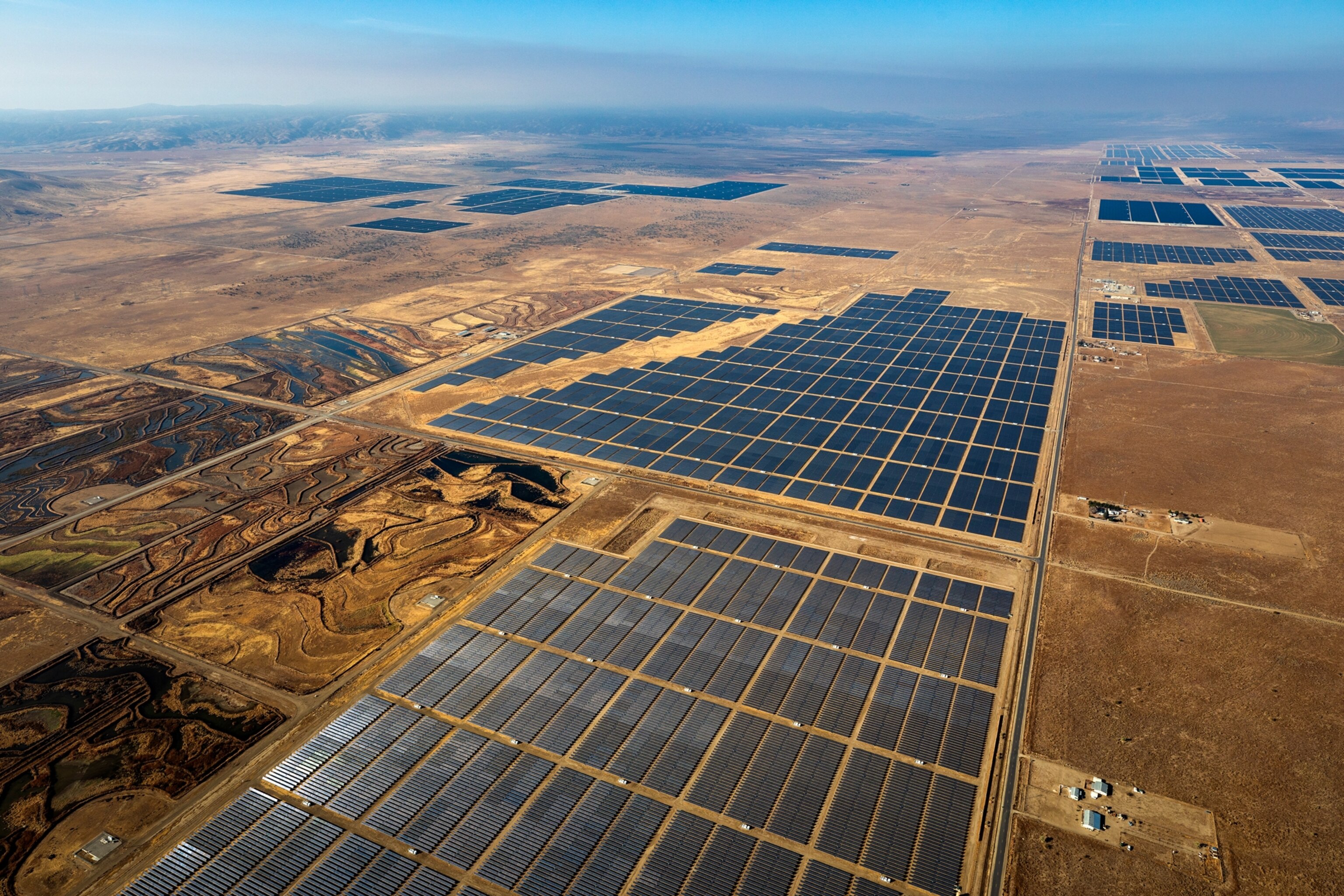 aerial of solar panels covering dry land