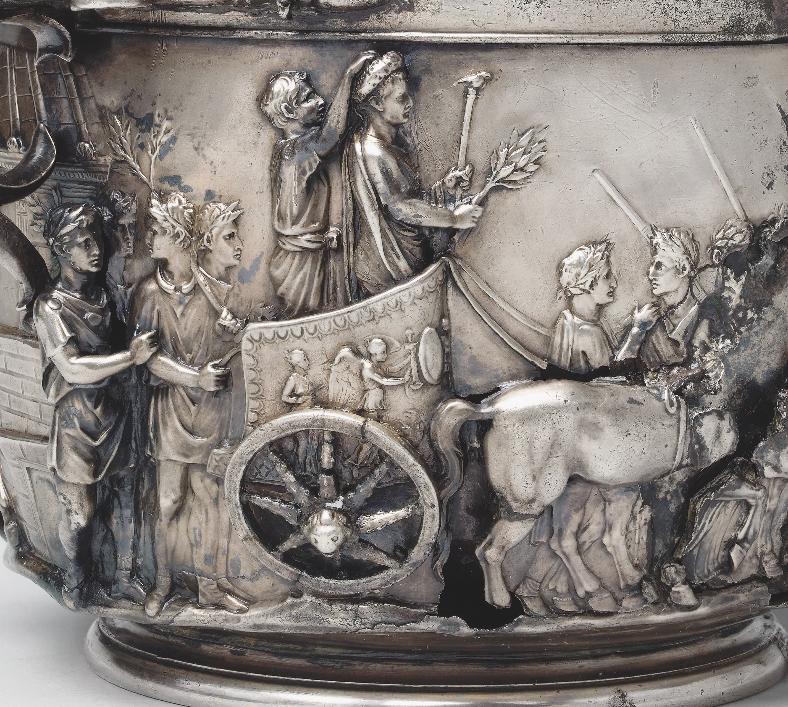 A silver engraving shows Tiberius in a chariot ride during his own triumph with a ivory scepter in one hand and a laurel branch in the other.