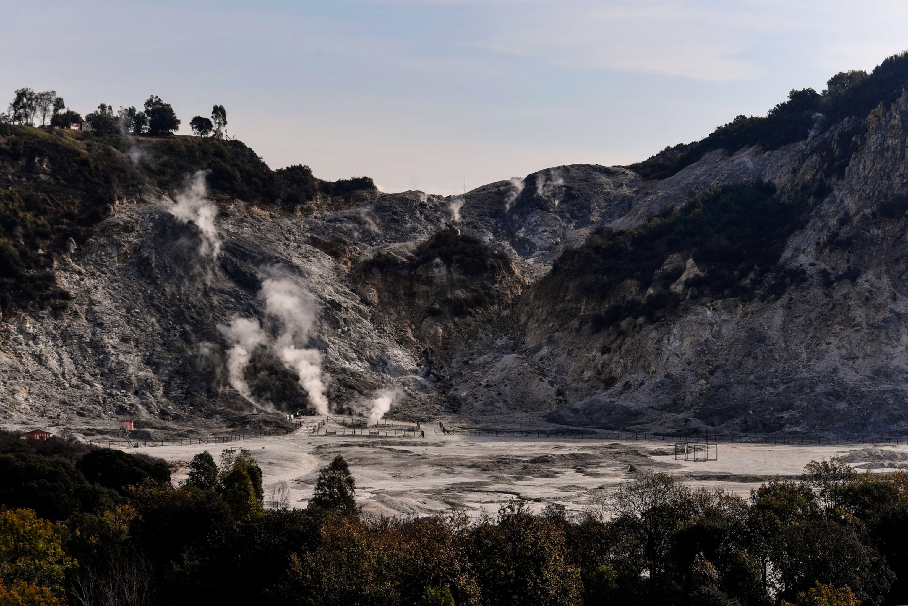 The Solfatara crater in midday light, with steam rising from the ground.