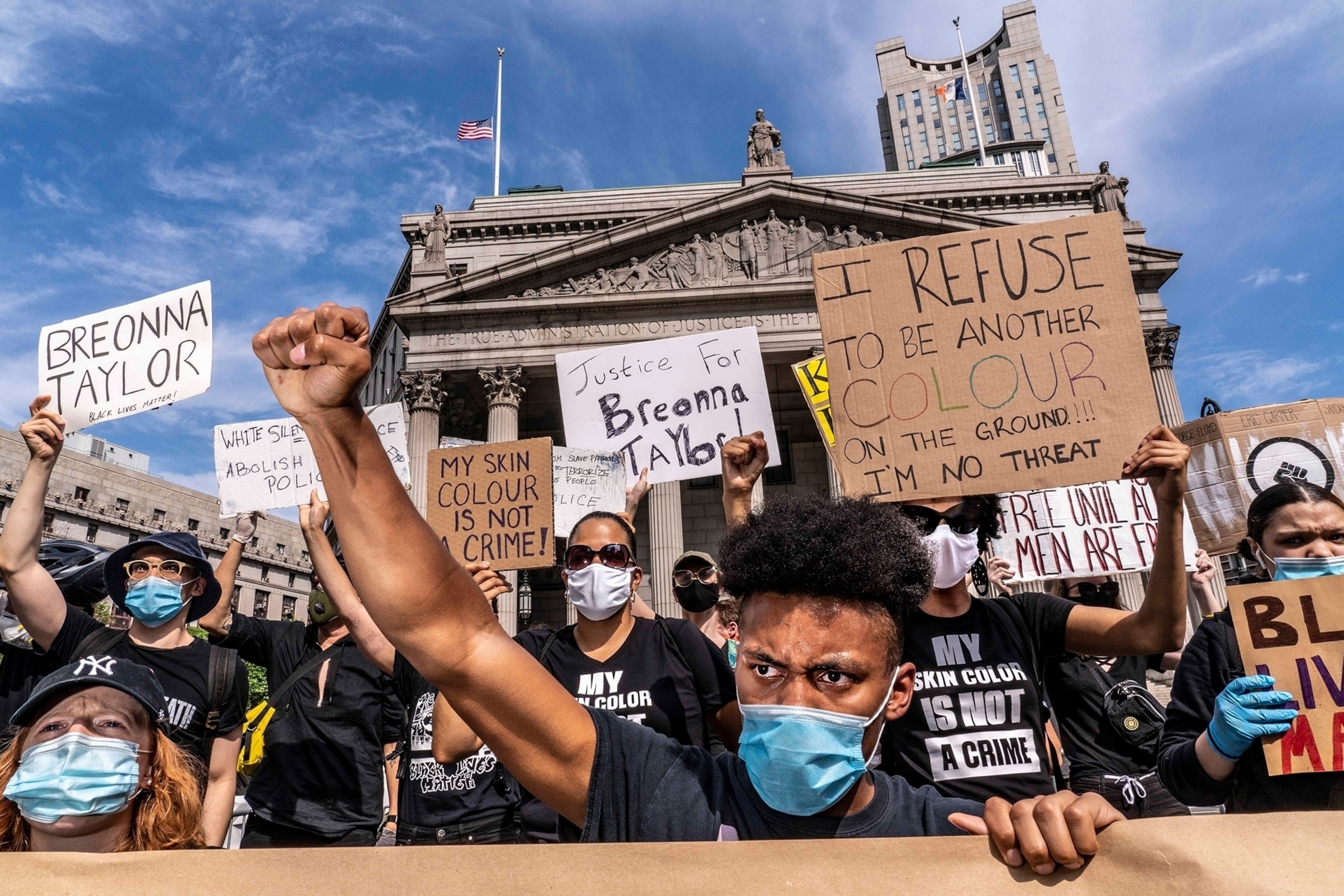 a man raising his fist at a protest