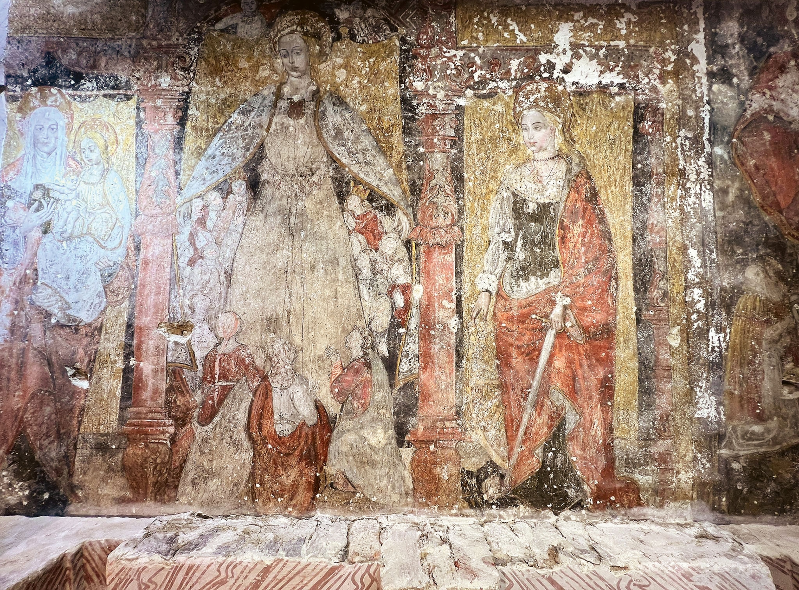 A worn fresco painting of the Virgin Mary