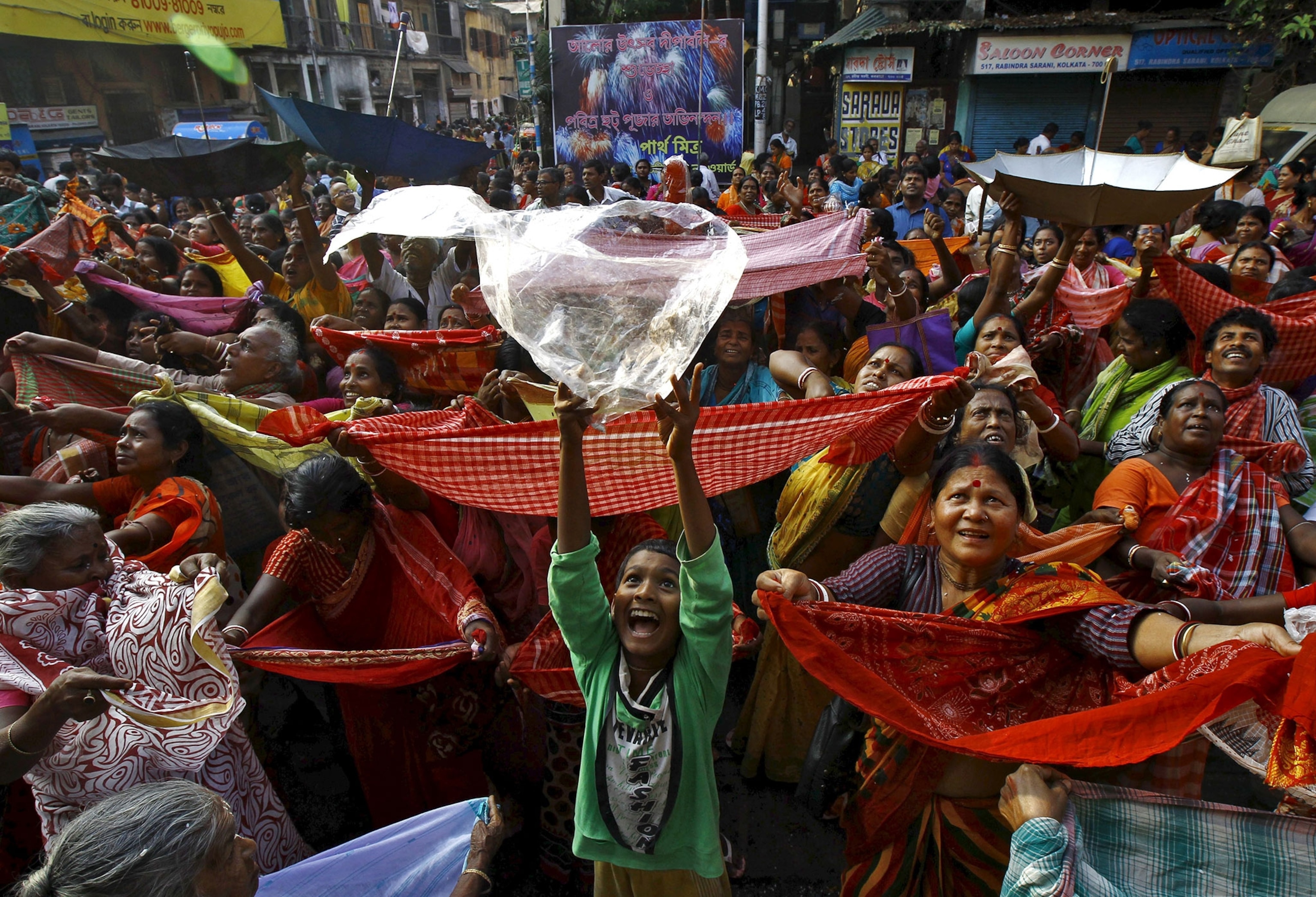 a boy holding up a plastic bag