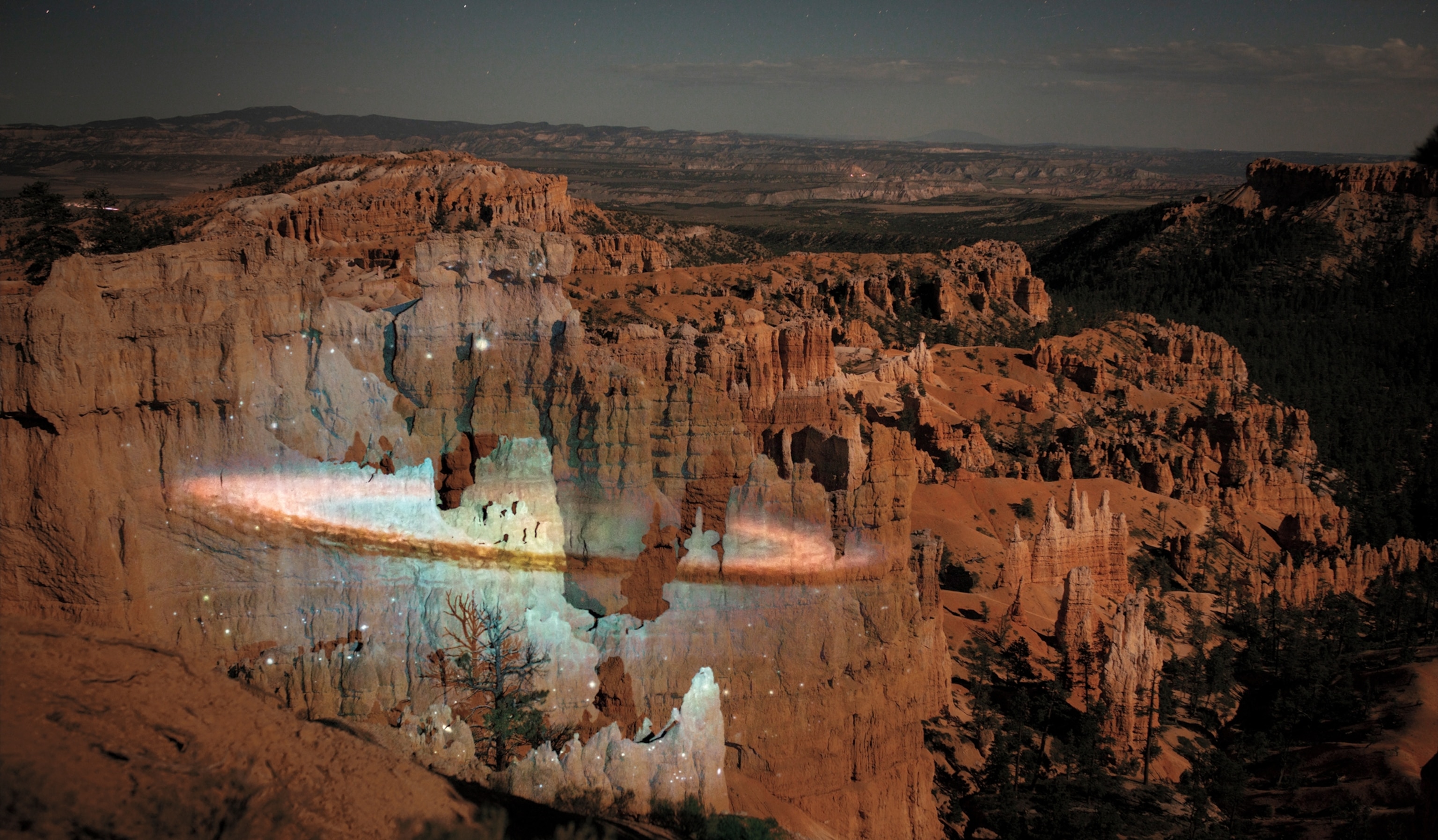 Bright white stars formation projected on the light brown wall of the canyon.