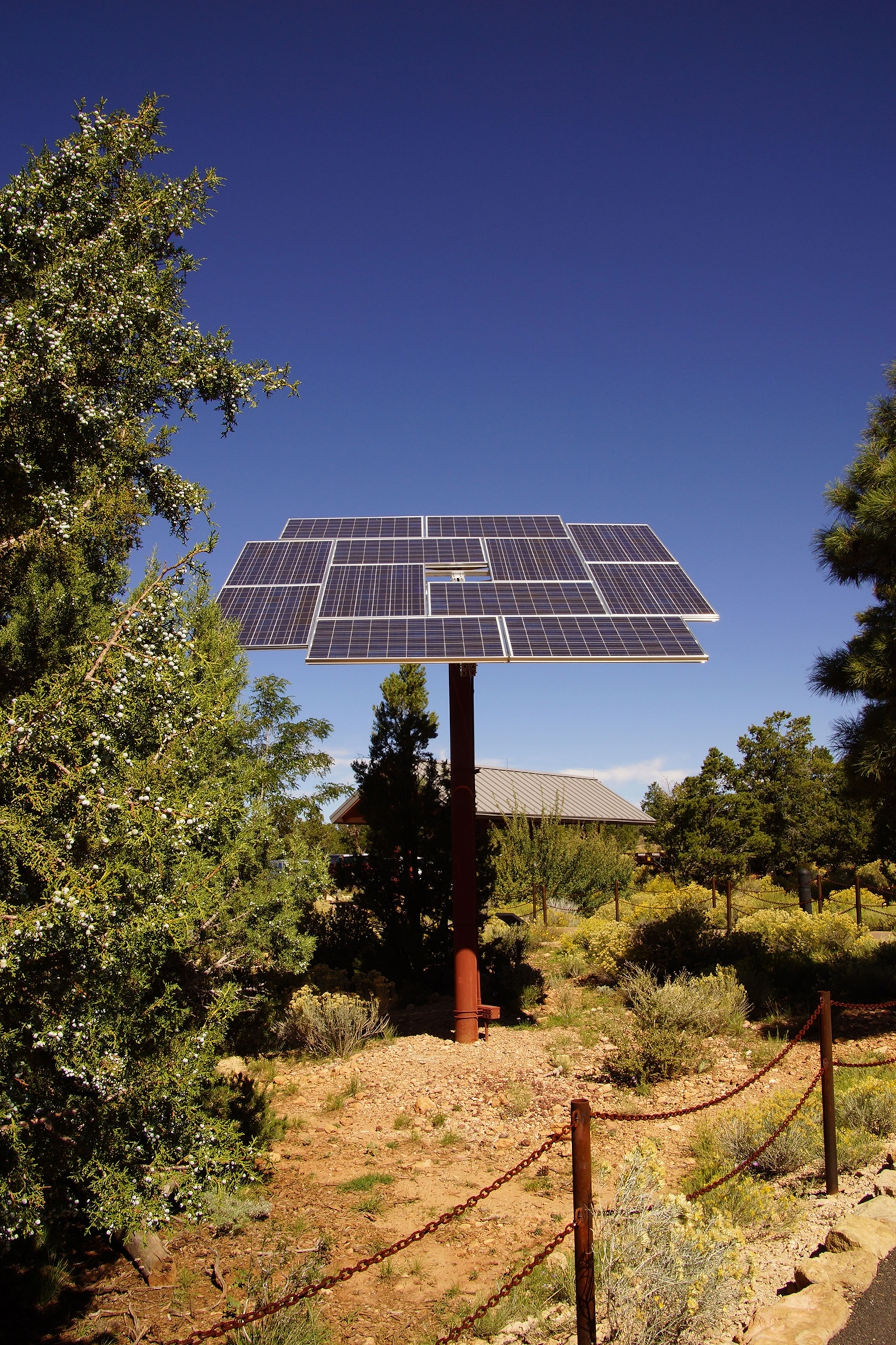 Solar panel in park. with building in background.