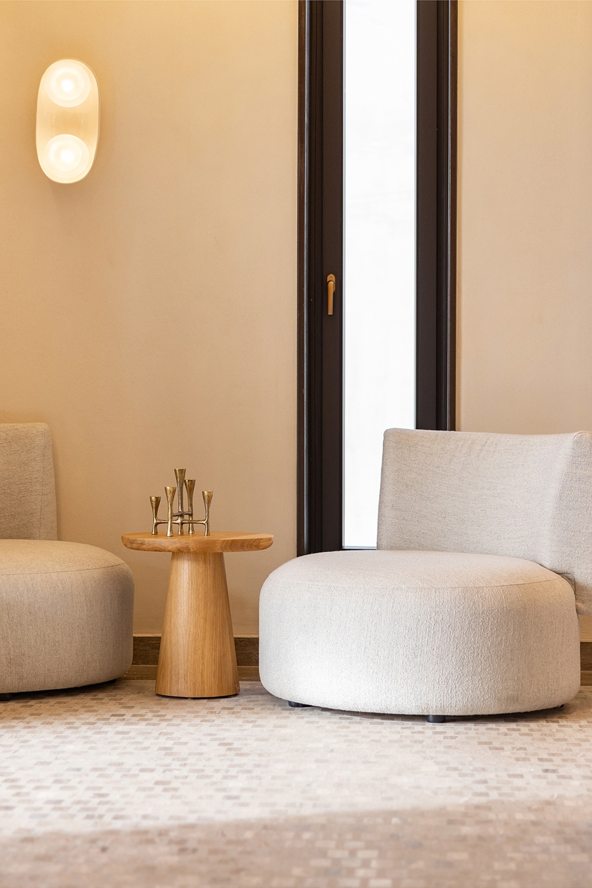 White chairs on a white carpe next to a wooden side table