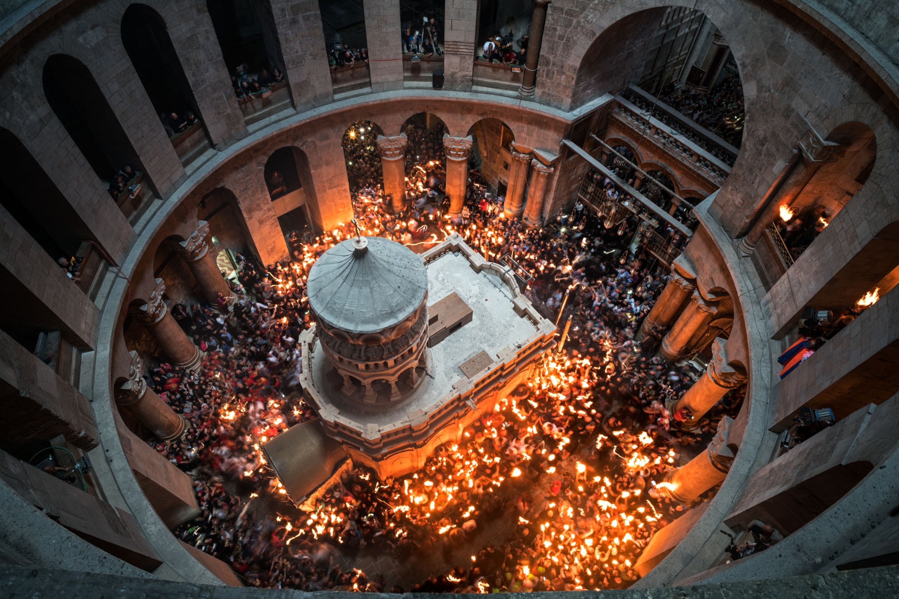 worshippers in Church of the Holy Sepulchre surround Edicule, Jerusalem.